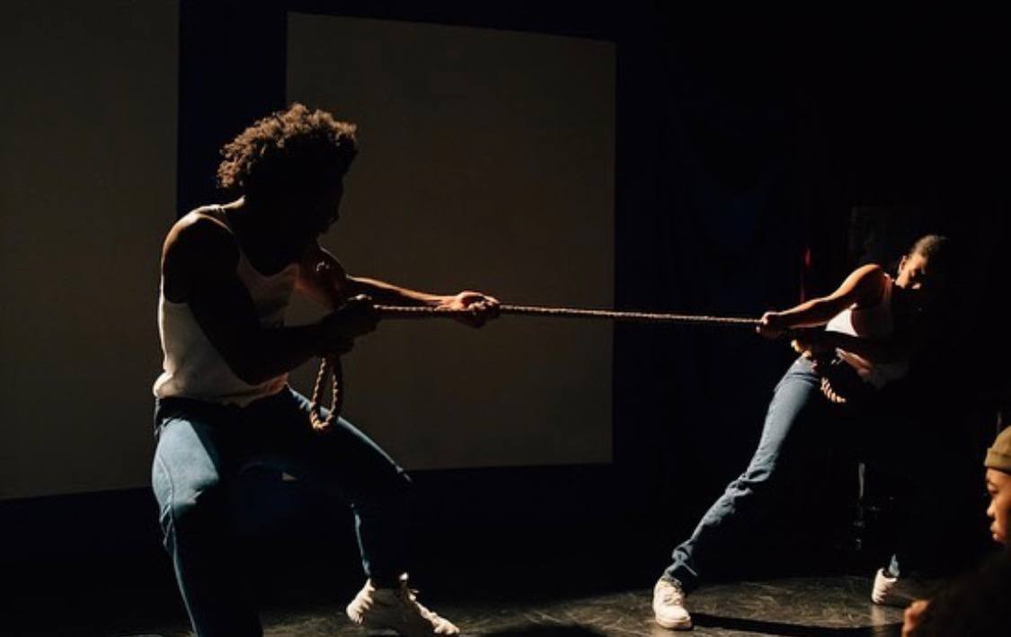 Two actors pulling on a rope