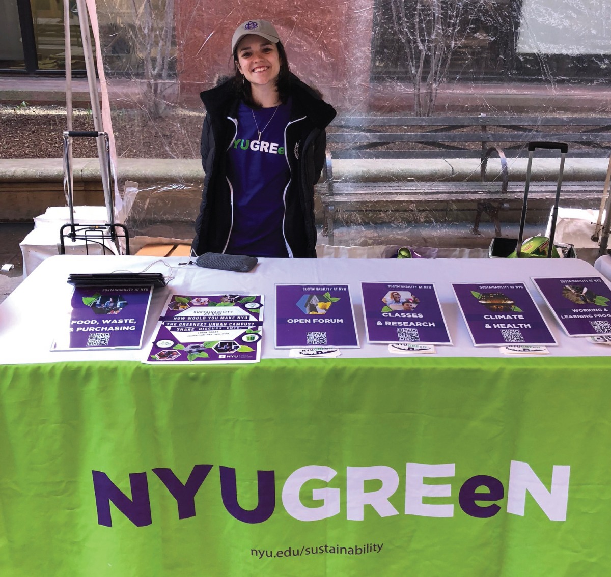 An NYU student managing a booth during the 