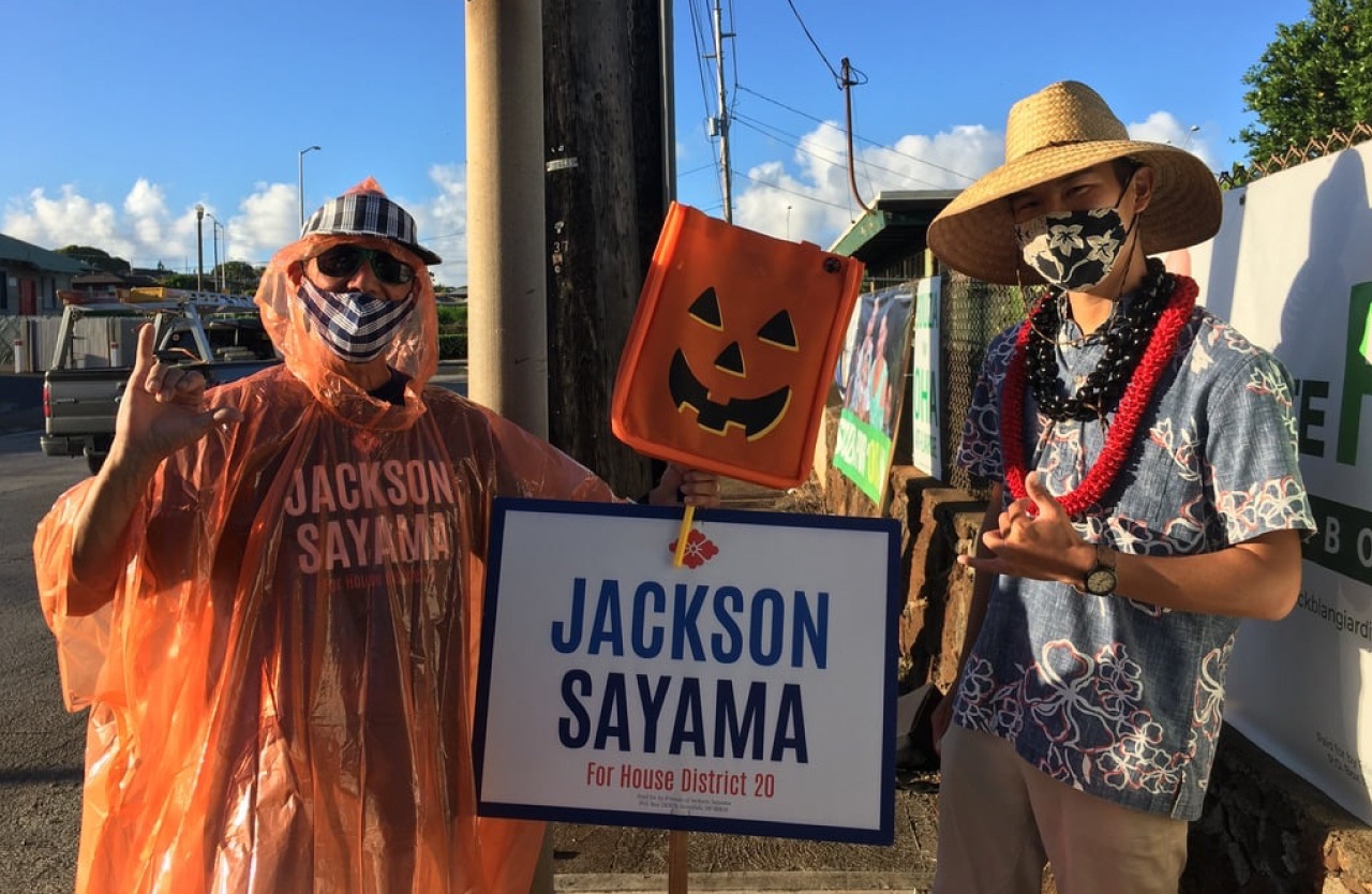 Jackson Sayama outside campaigning with a volunteer for his run as a Hawaii House Representative