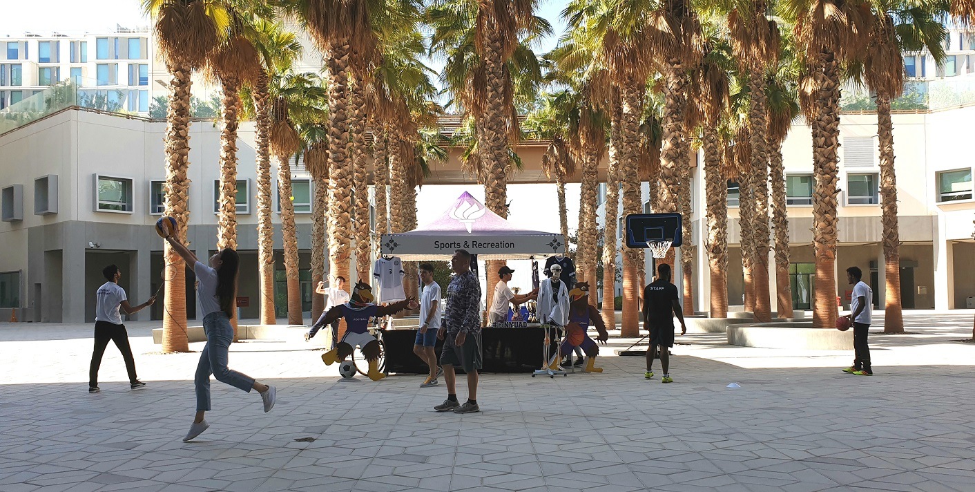 NYU Abu Dhabi students playing sports in the plaza.