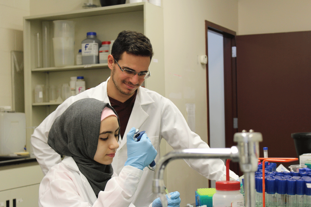 Two college students working in a lab.