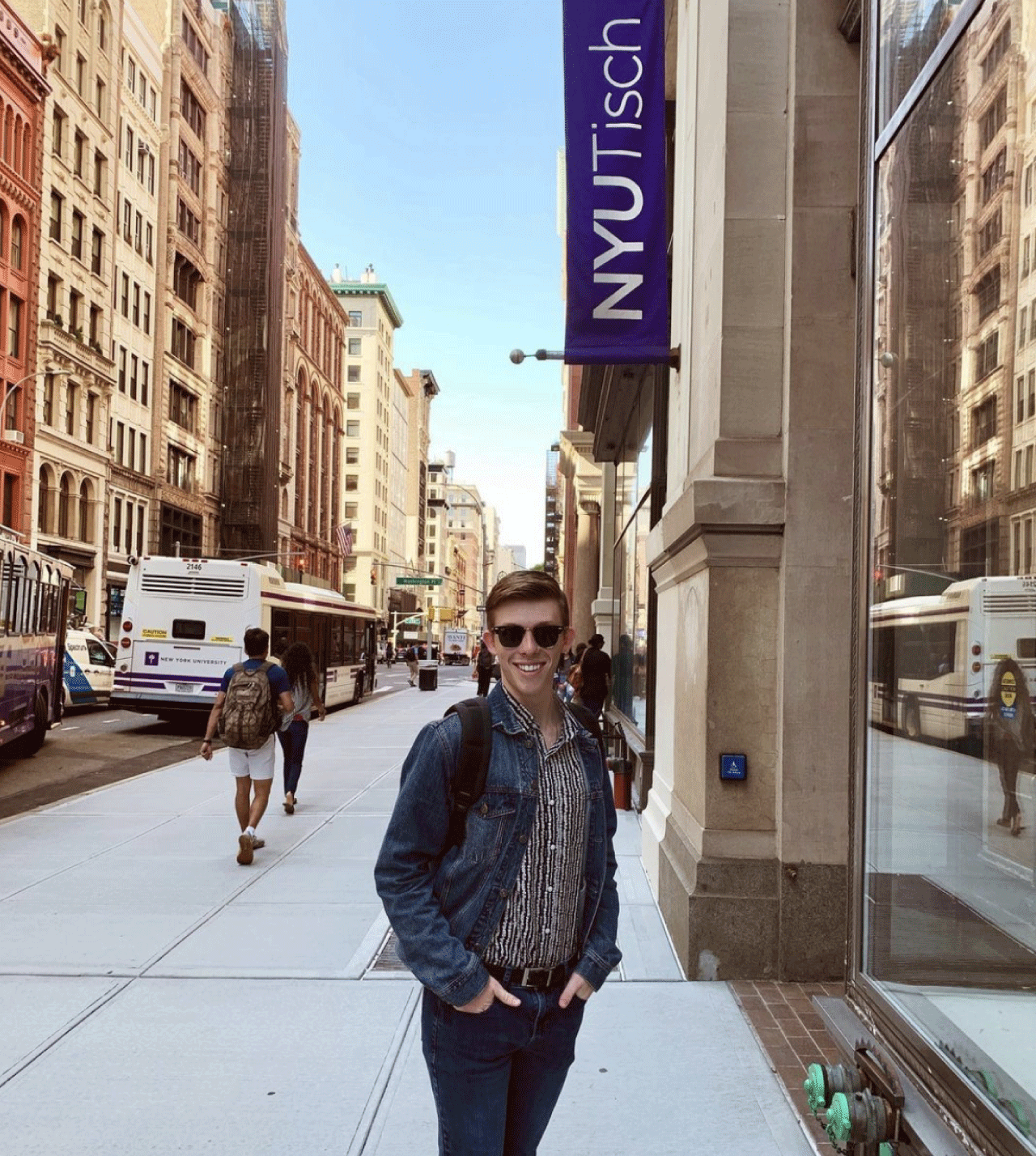 J.R. Heckman smiling in front of the NYU Tisch building