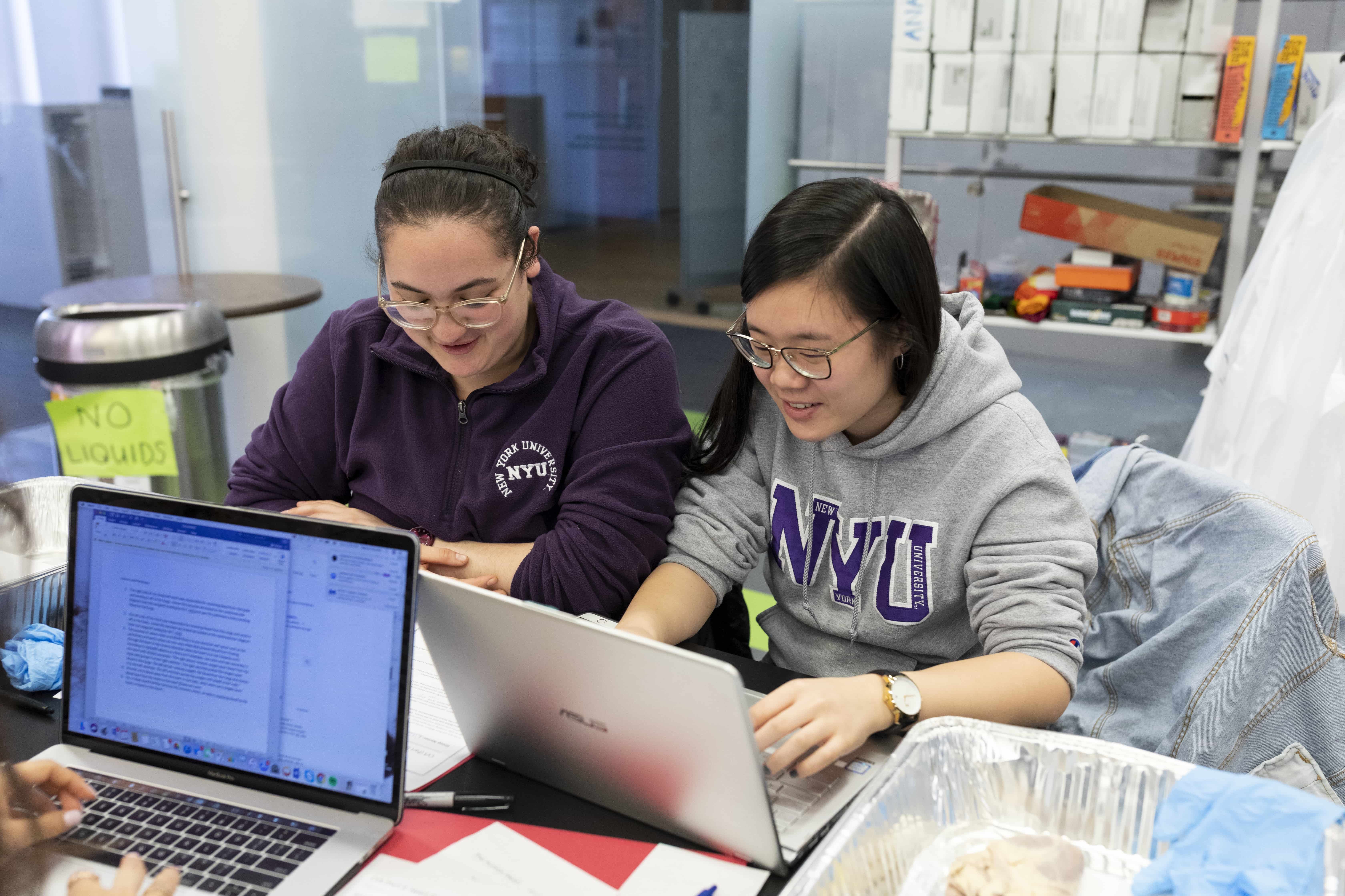 Two students working together in a lab on campus.
