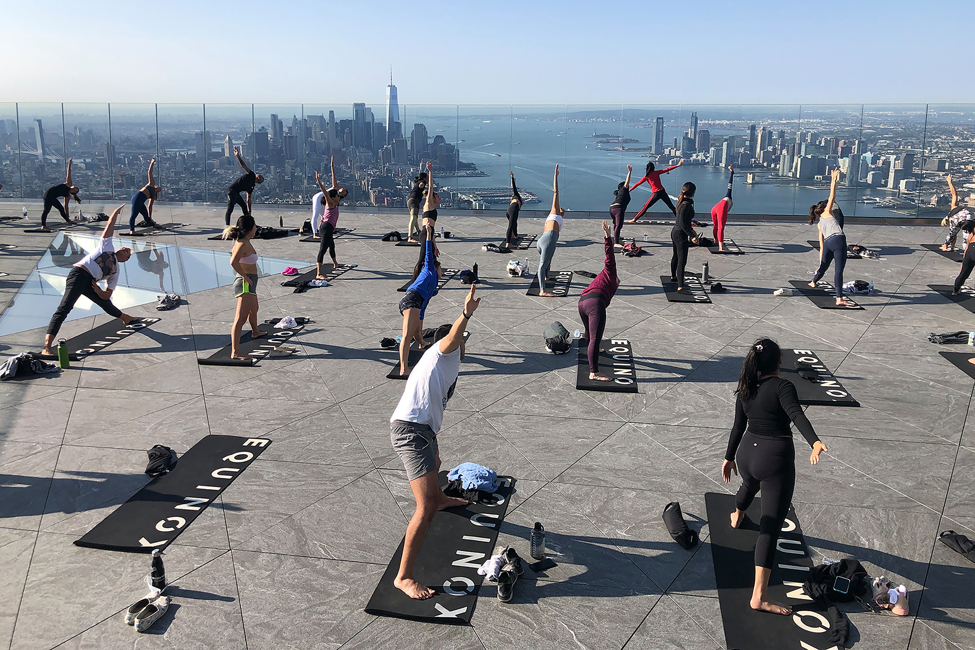 People practicing yoga on a rooftop.