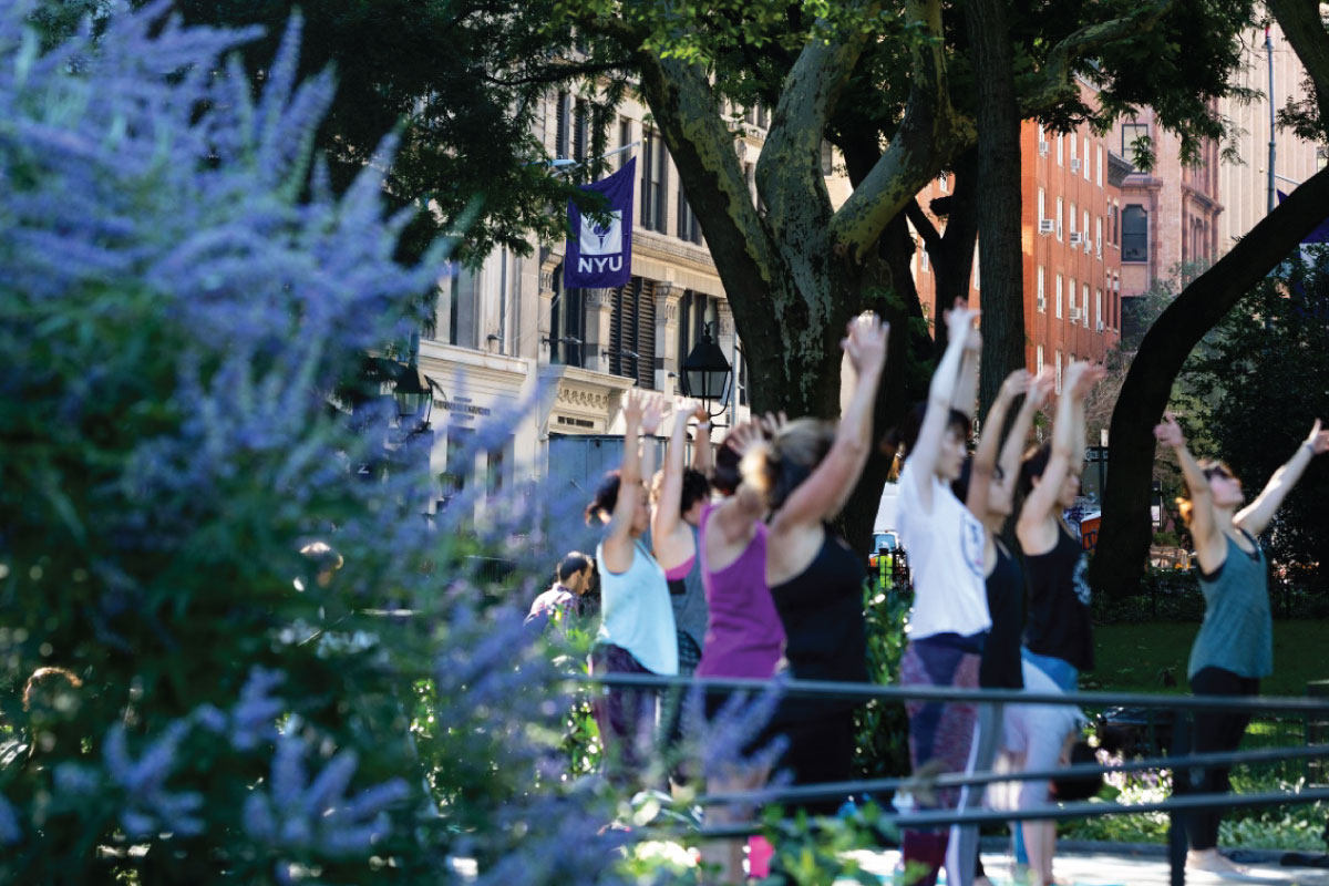 A group of people doing yoga in Washington Square Park