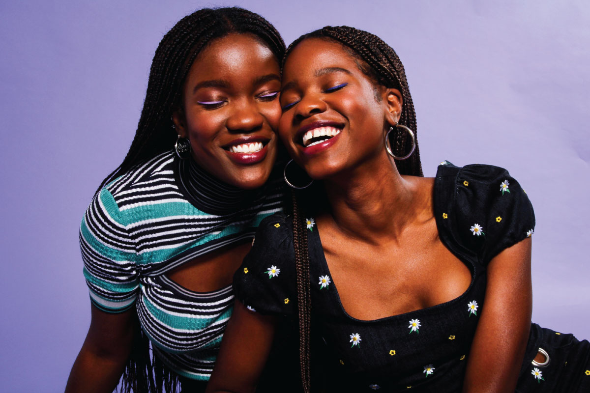 Two Black women smiling.