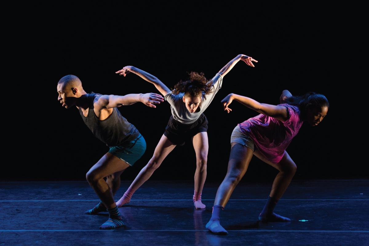 Three student dancers on stage.