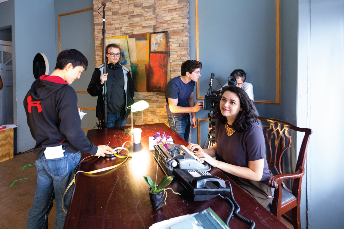 A group of students conducting creative research on a film set.
