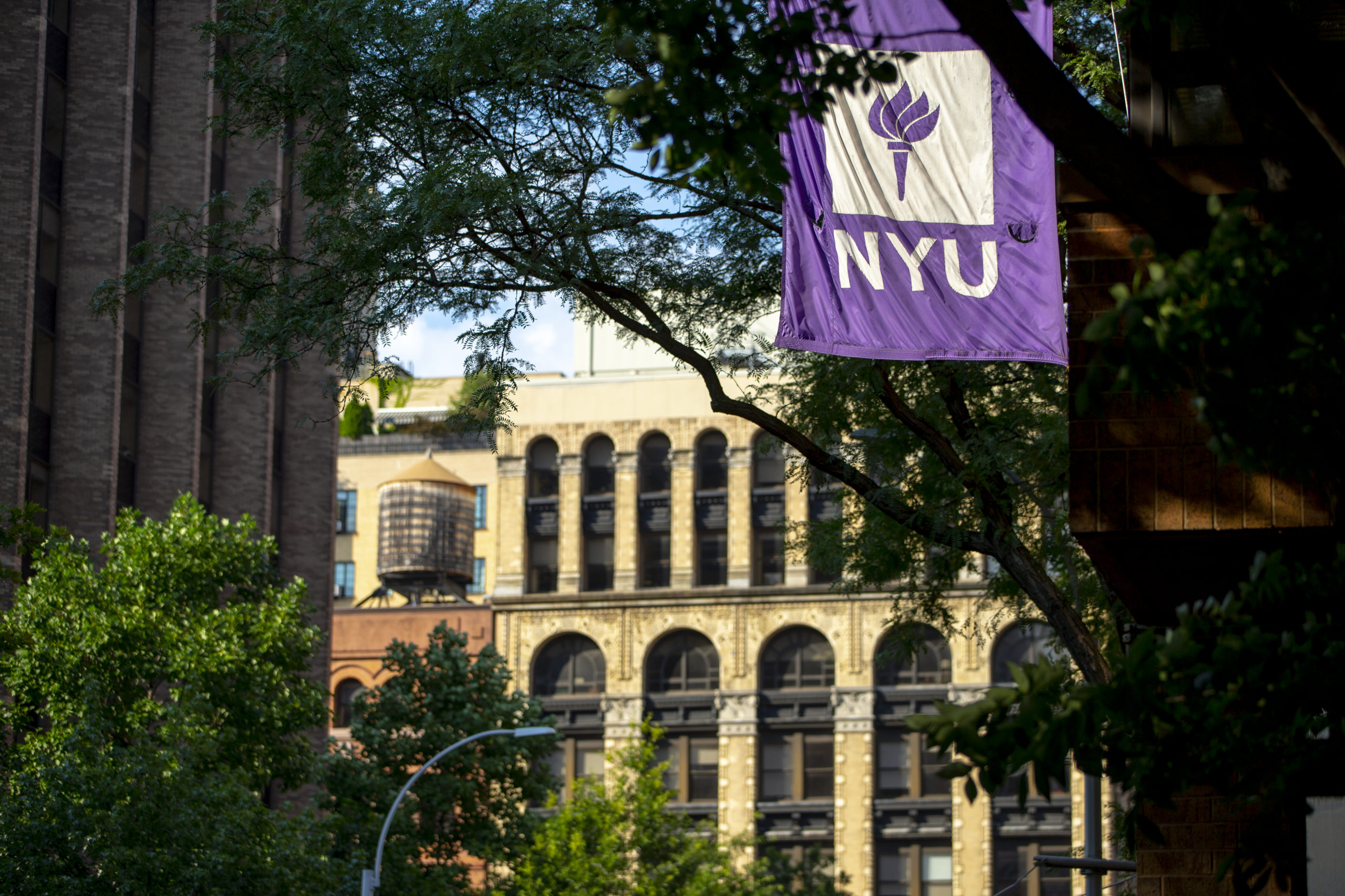 NYU campus buildings and flag.