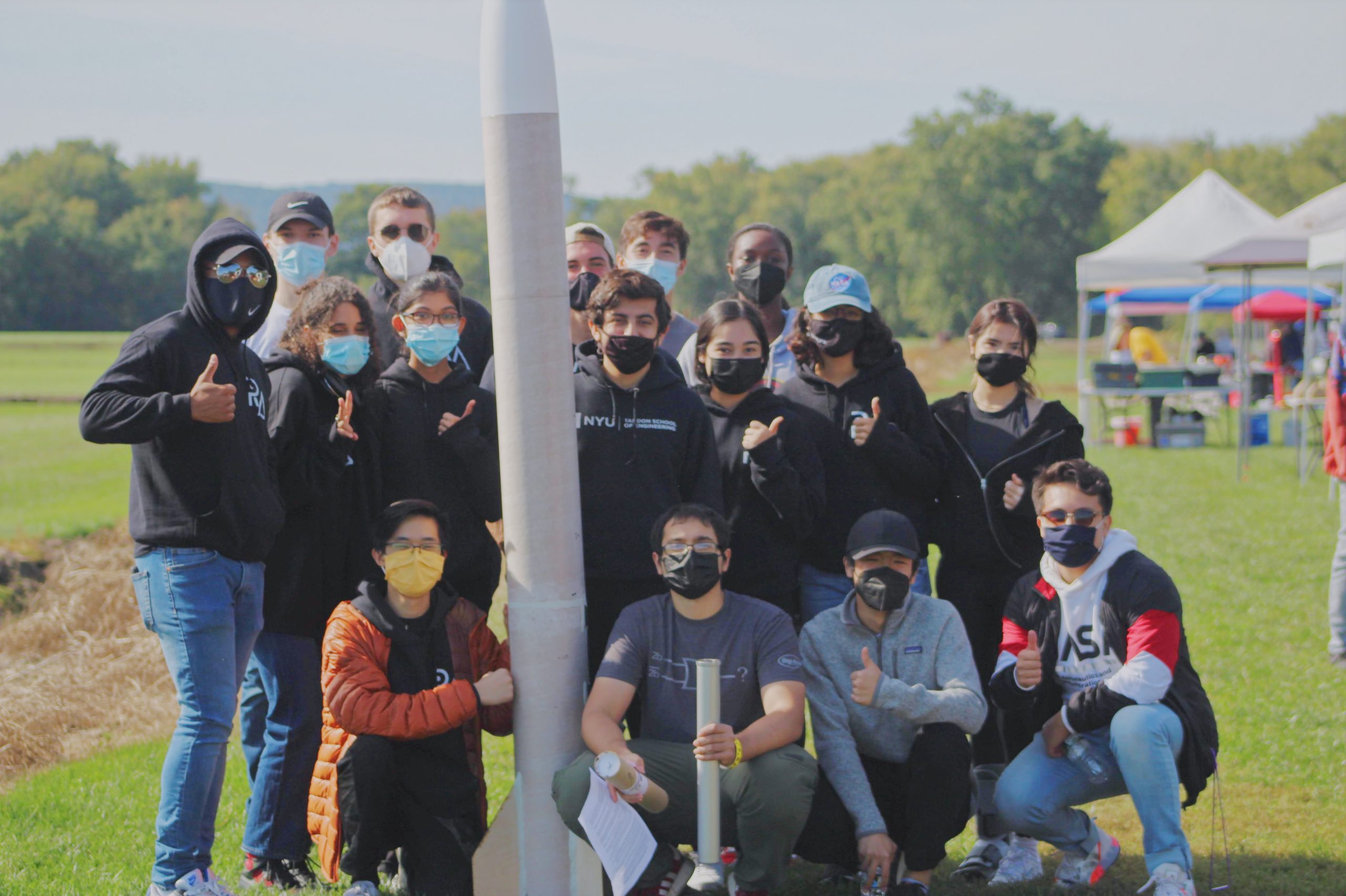 A group of students with a rocket they created