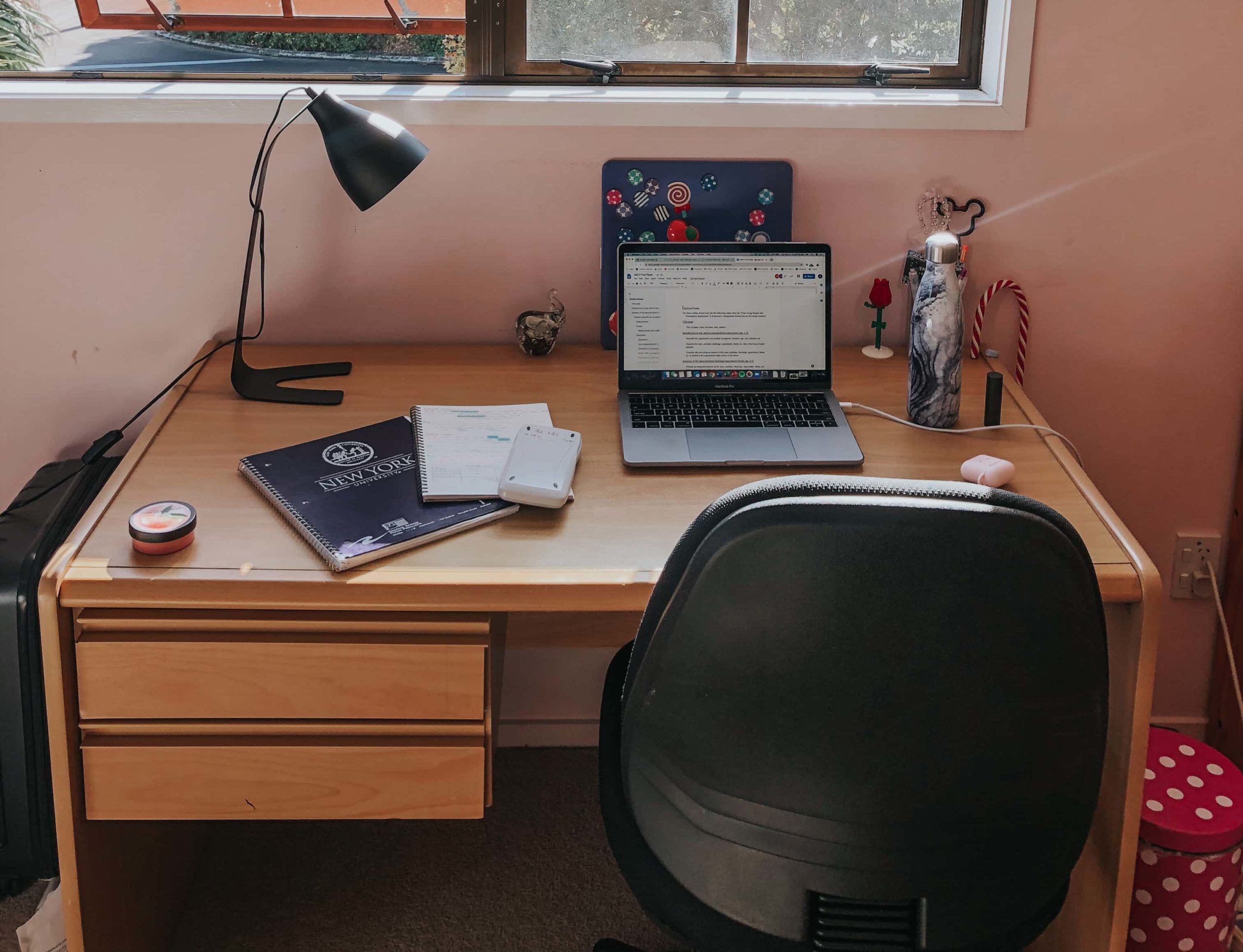 A laptop computer and reading lamp on a desk.