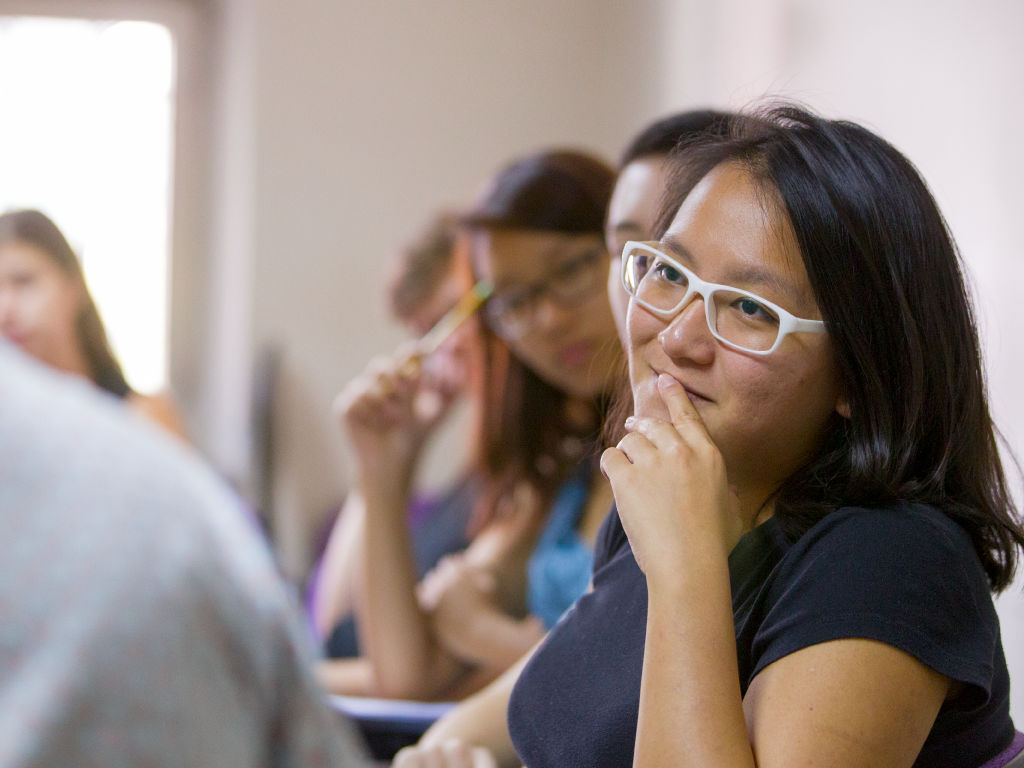 A close up of a student in a classroom.