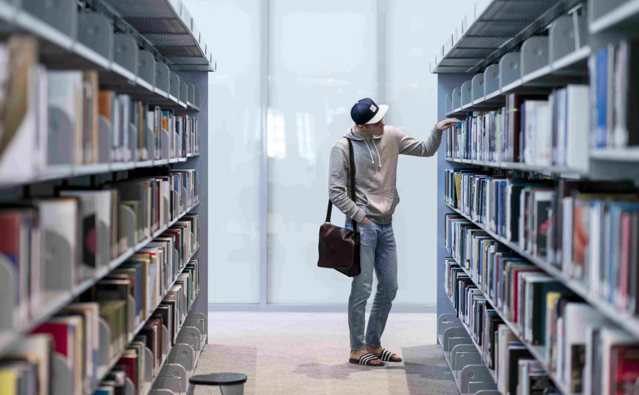 A student browsing books in the library.