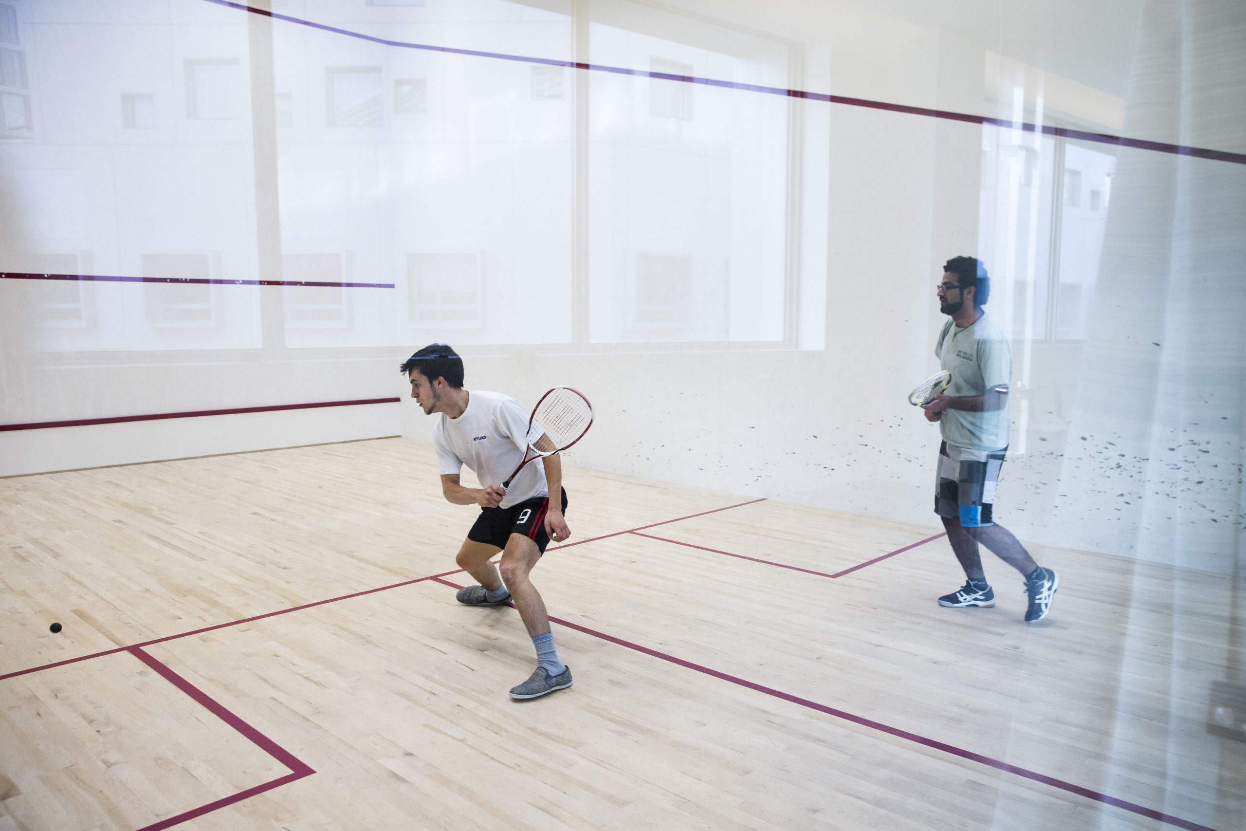 Two students playing squash at NYU Abu Dhabi.