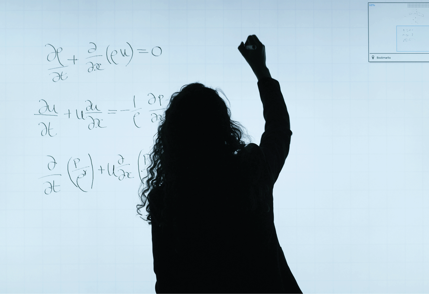 A student writing equations on a whiteboard.