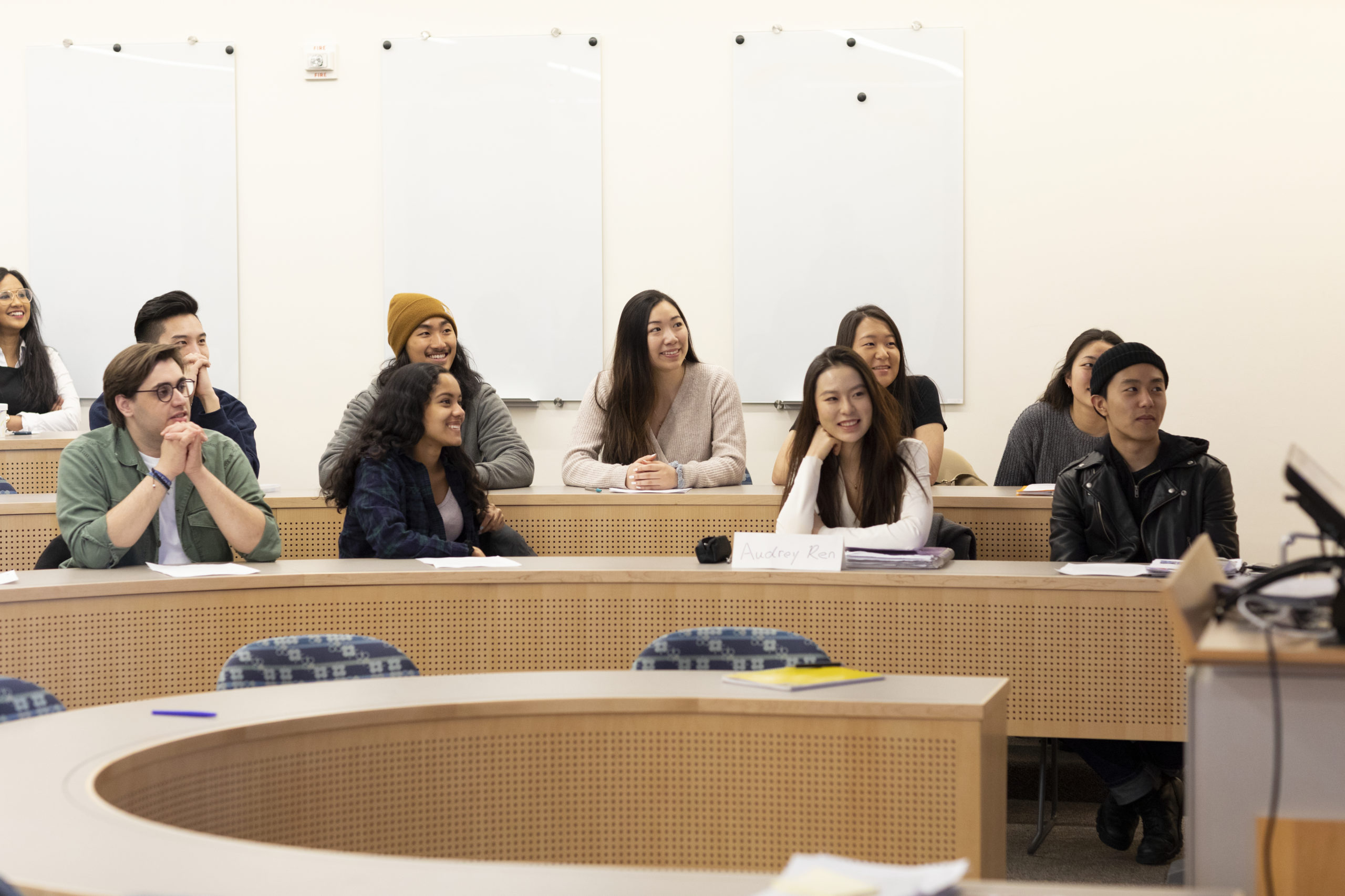 A group of students sitting in a lecture hall.