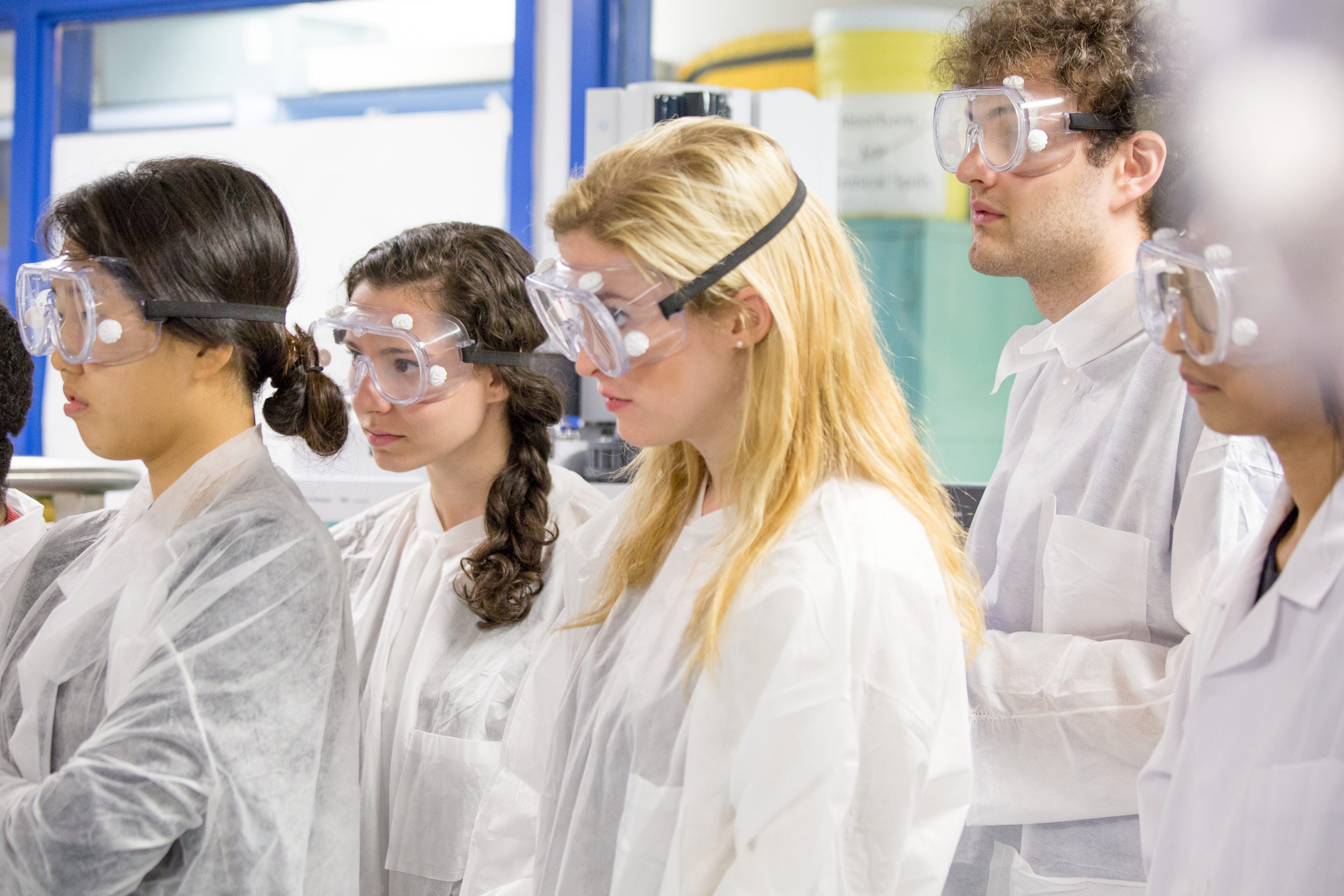 Students in a lab wearing safety equipment.