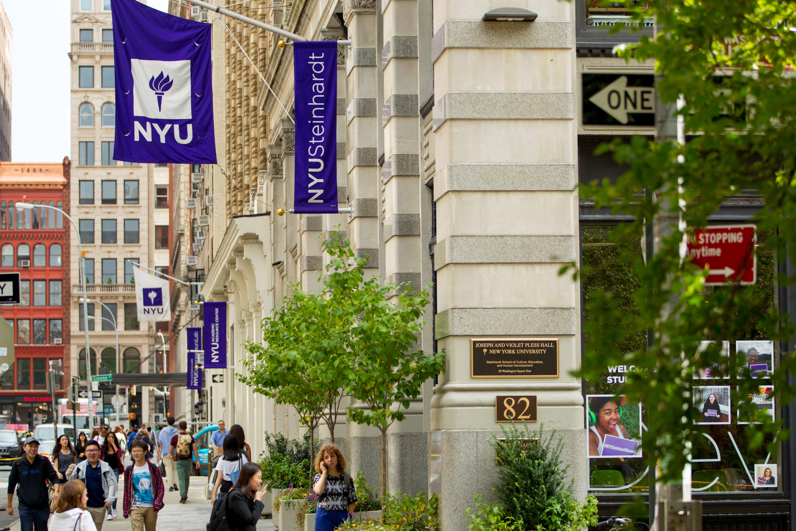 The exterior of the NYU Steinhardt building. People walk on the sidewalk next to it.