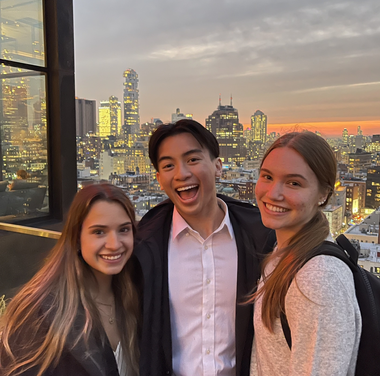 The author at a hotel with two friends. The New York City skyline is behind them.