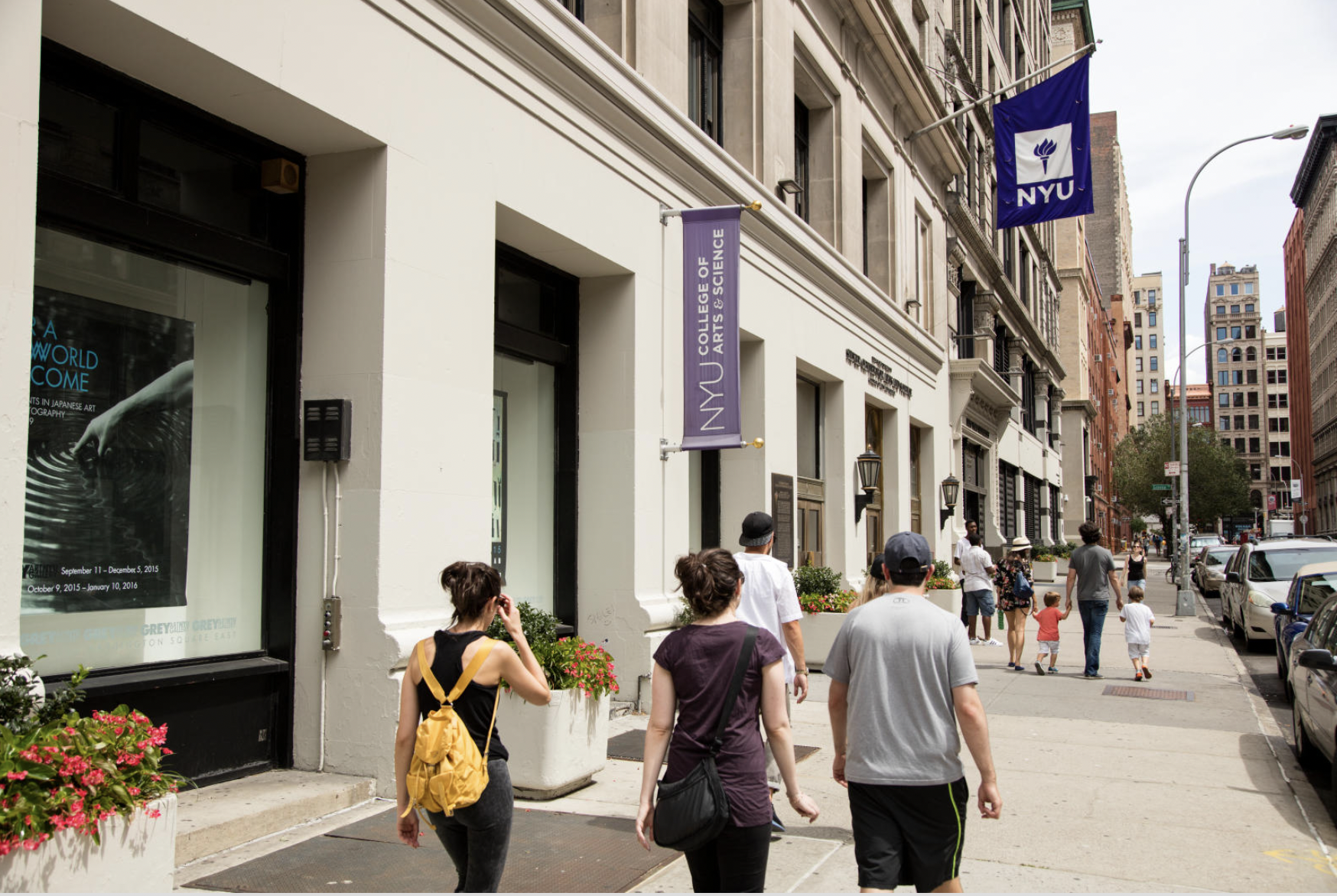 A community of students passing by the NYU College of Arts and Science building.