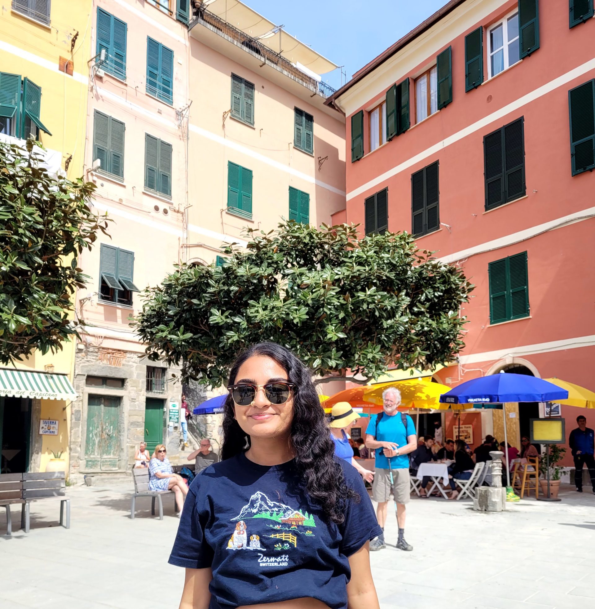 Eshika in front of the colorful buildings in Cinque Terre.