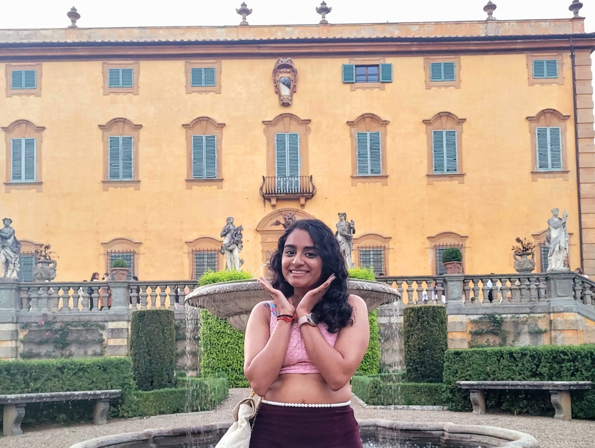 Eshika in front of NYU Florence’s yellow Villa La Pietra.