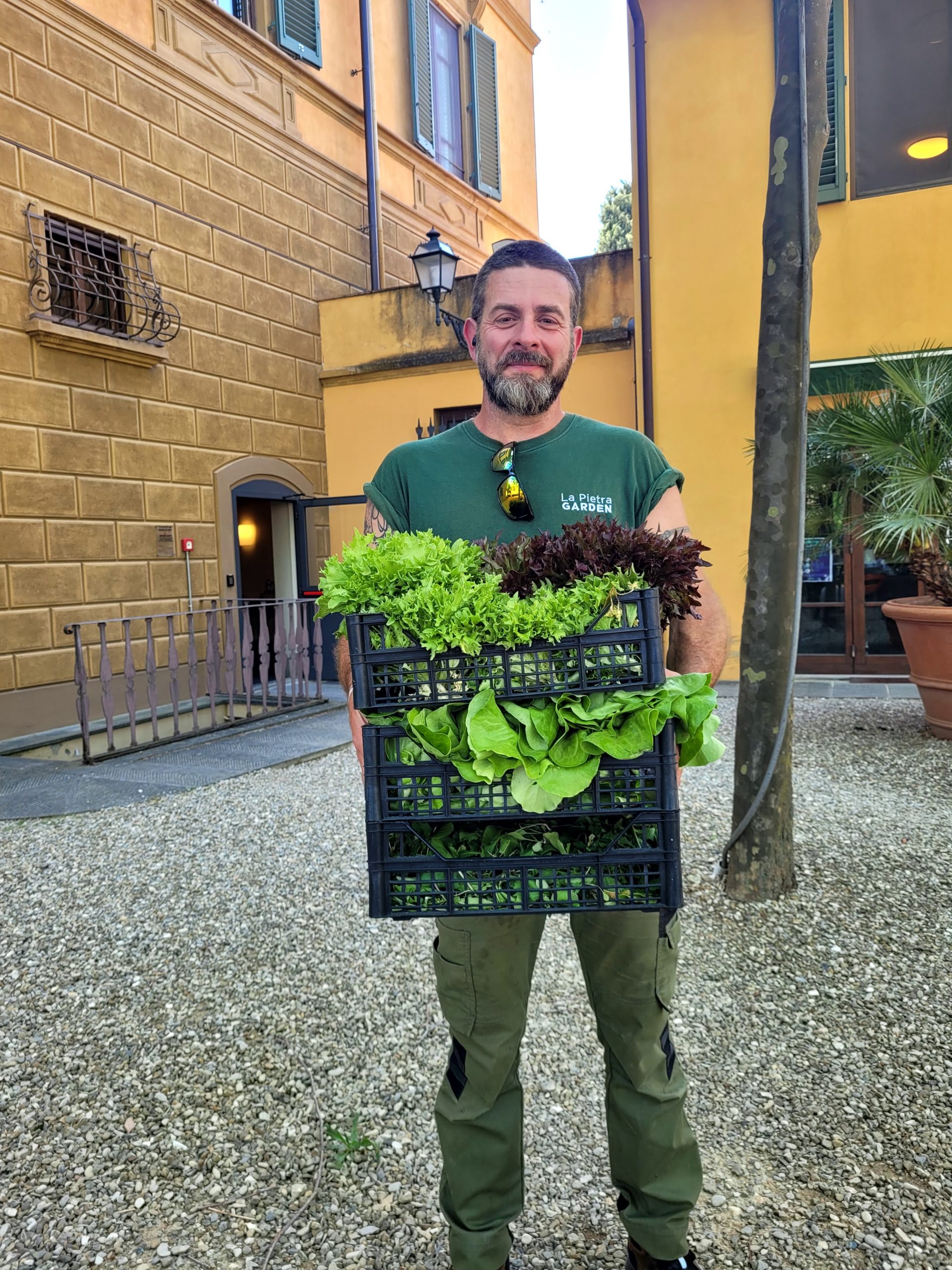 An NYU faculty member carrying fresh veggies from the Villa La Pietra garden to be used in the dining hall.
