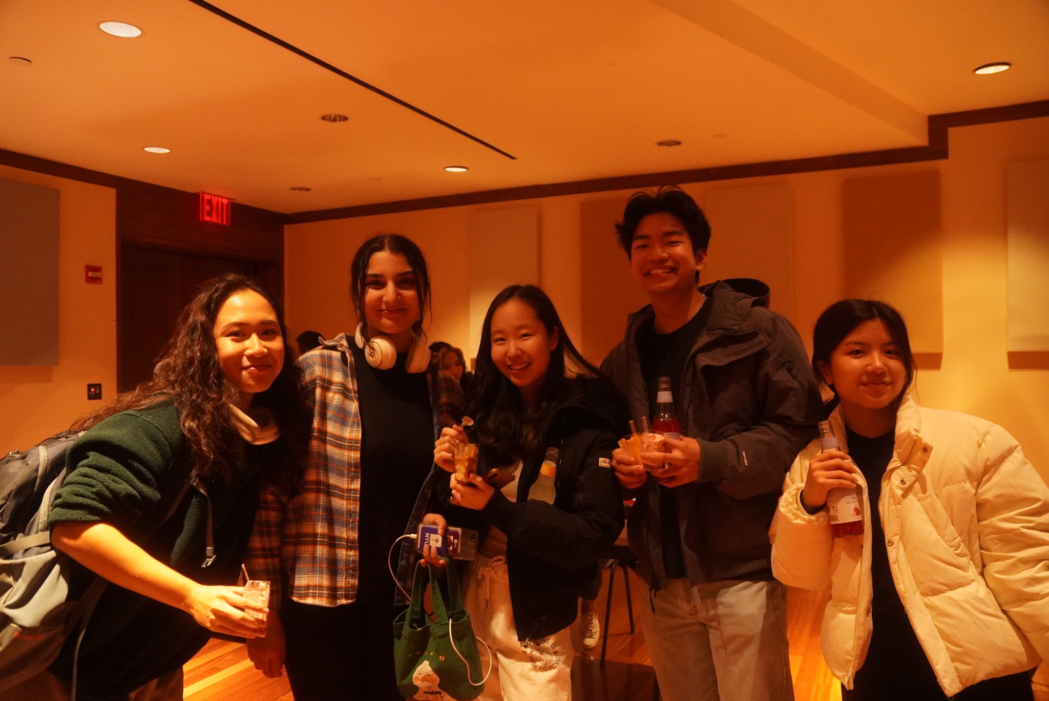 Students smiling for the camera, holding mousse cups and yuzu drinks.