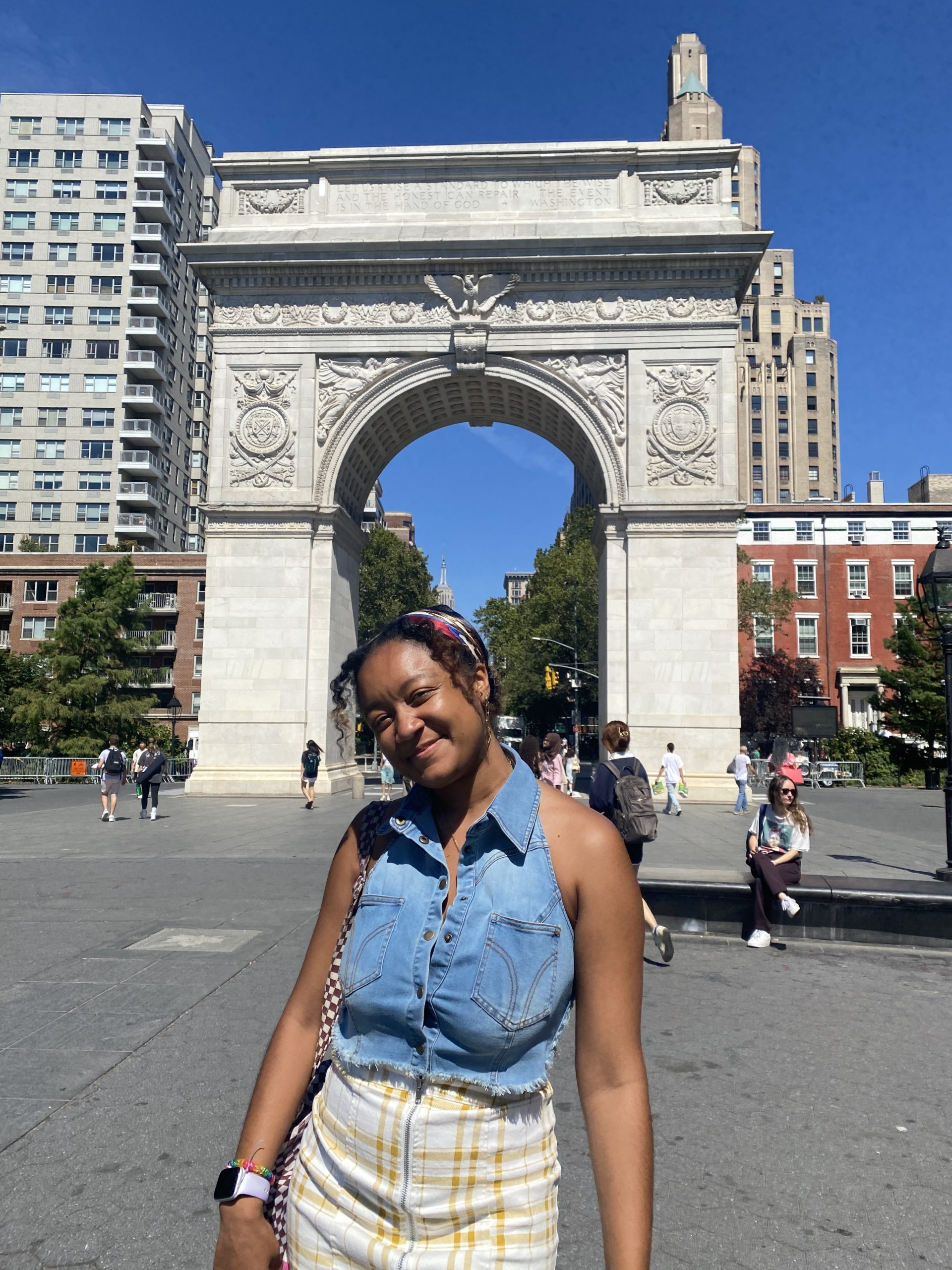 Student standing in front of Washington Square Arch in Washington Square Park