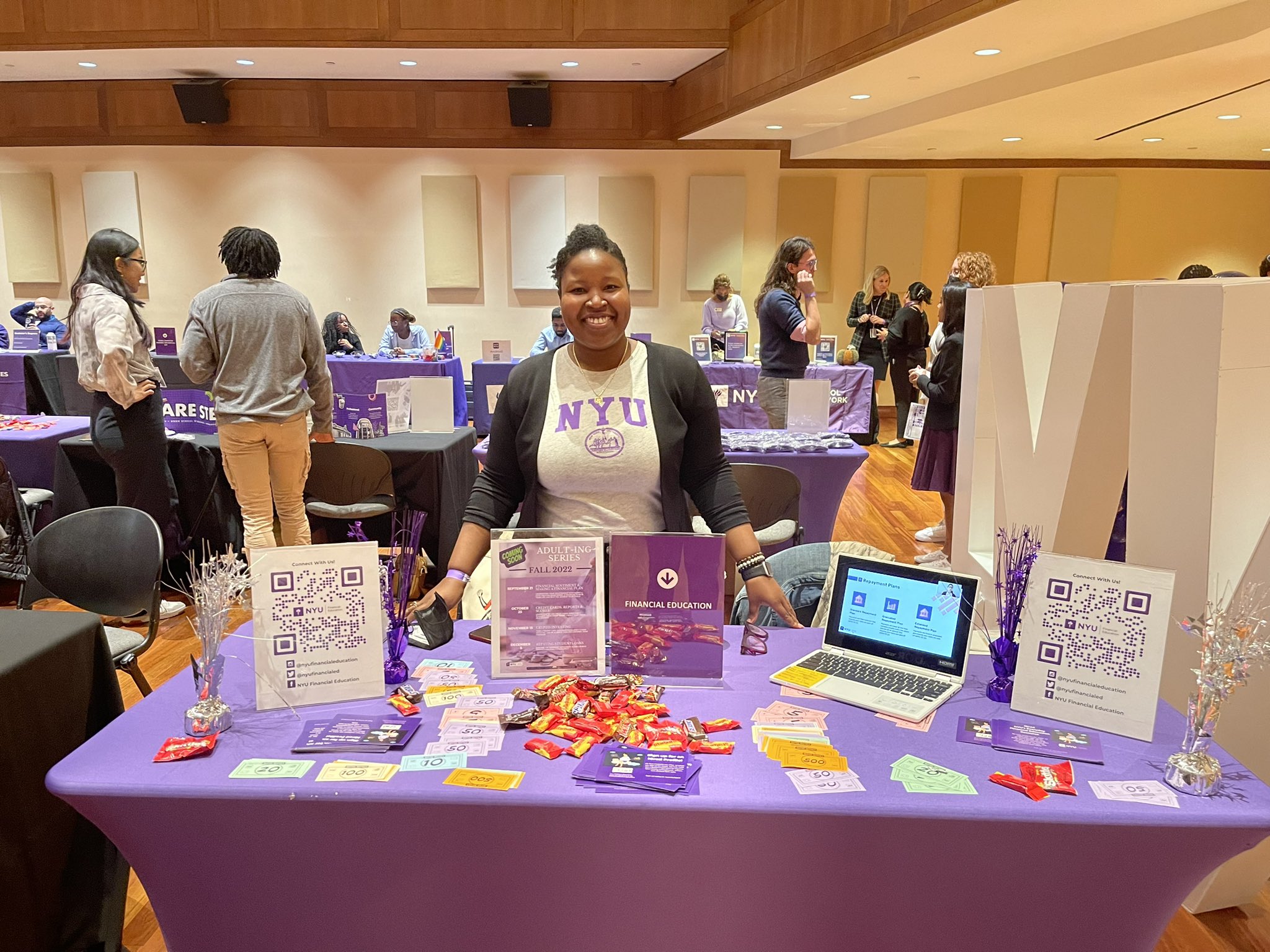 NYu Financial Ed officer at a table of info packets and candy at Fall Open House