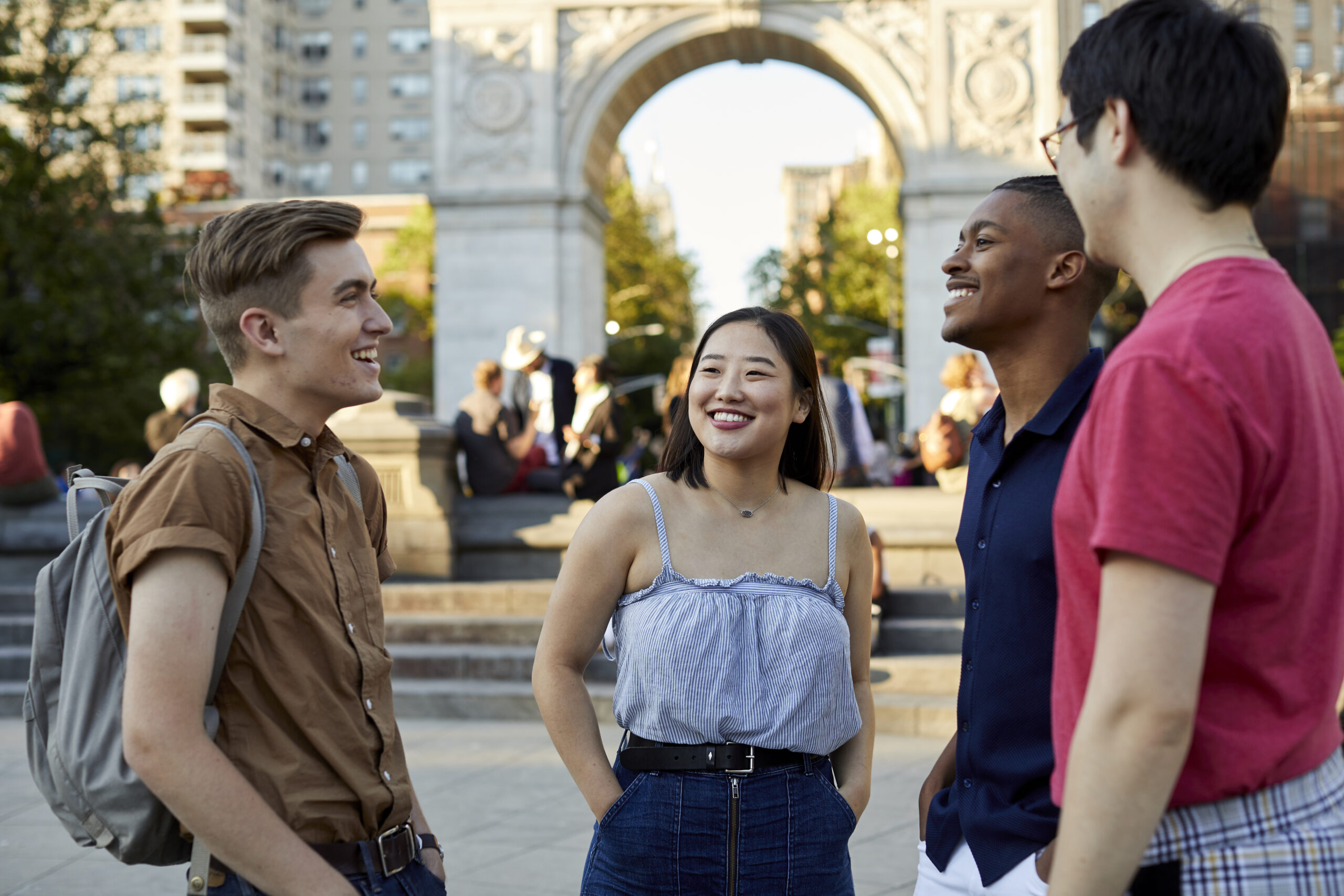Students smiling together in Washington Square Park.