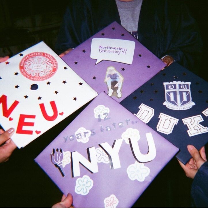 The author’s NYU graduation cap after she has decorated it and friends’ caps from other universities.