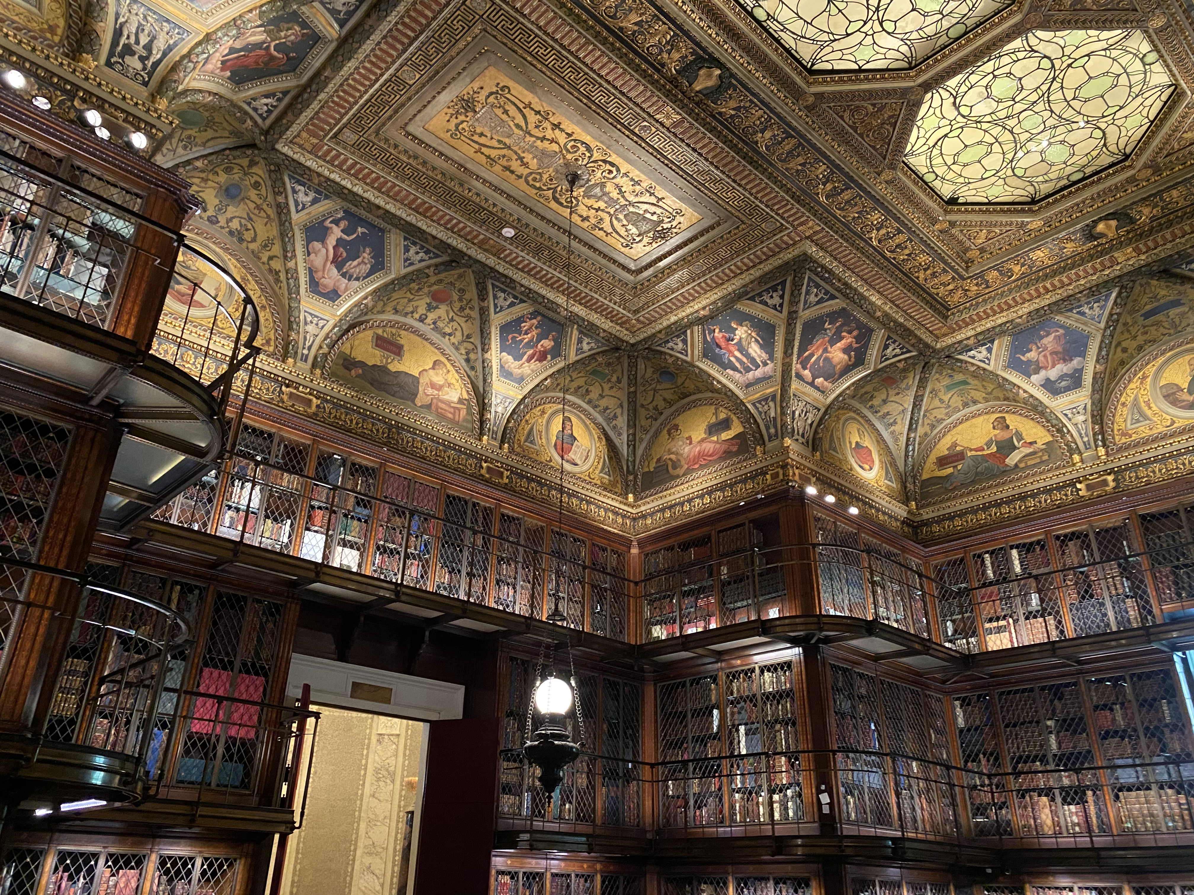 A highly-ornate historic room filled with books in the Morgan Library.
