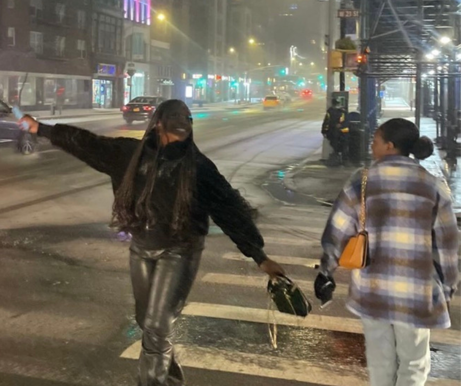 Two students strut across a snowy crosswalk