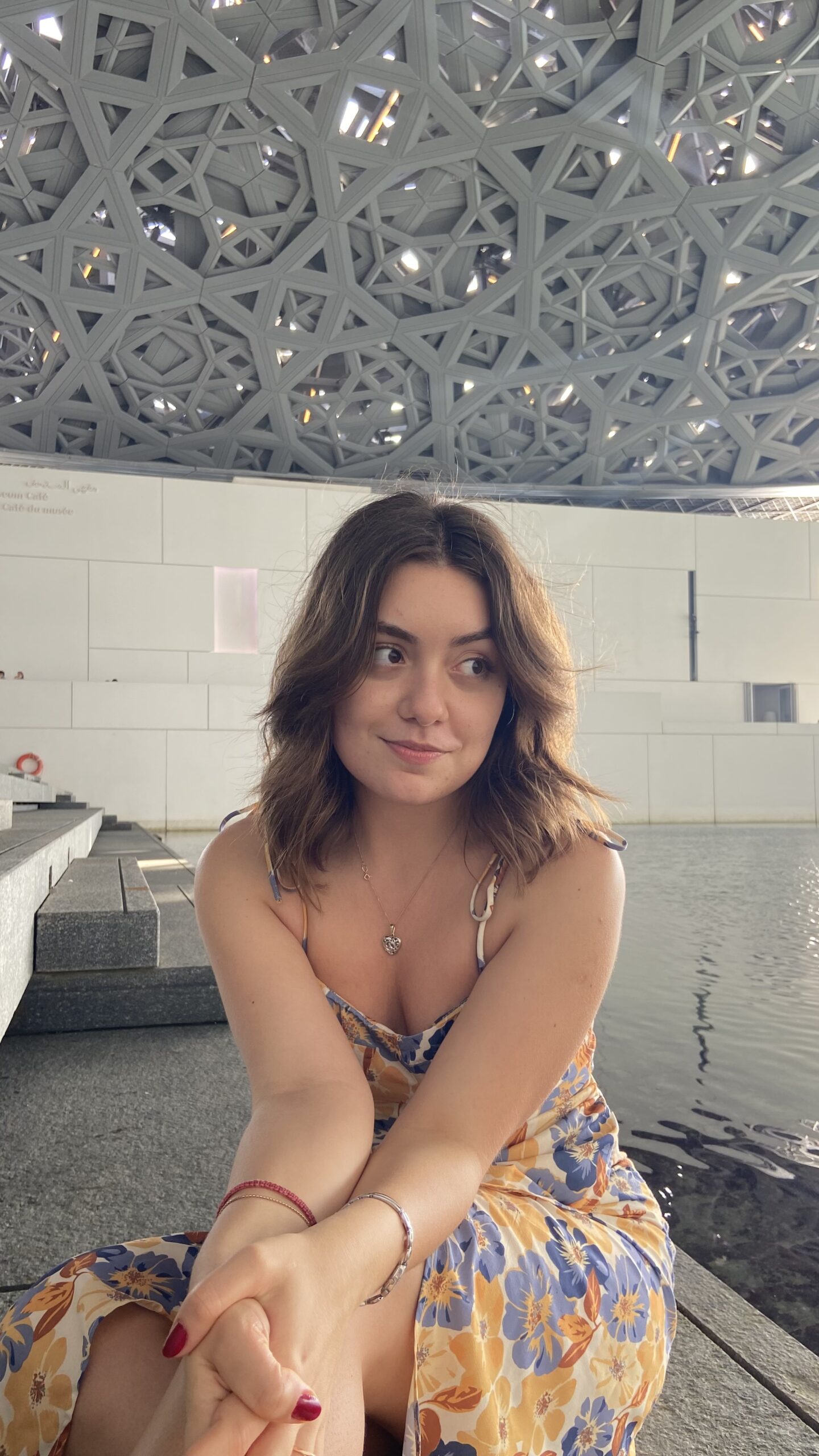 Amina sitting in a gallery at Louvre Abu Dhabi