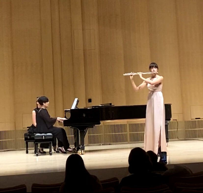A flutist and pianist performing onstage at NYU Abu Dhabi.