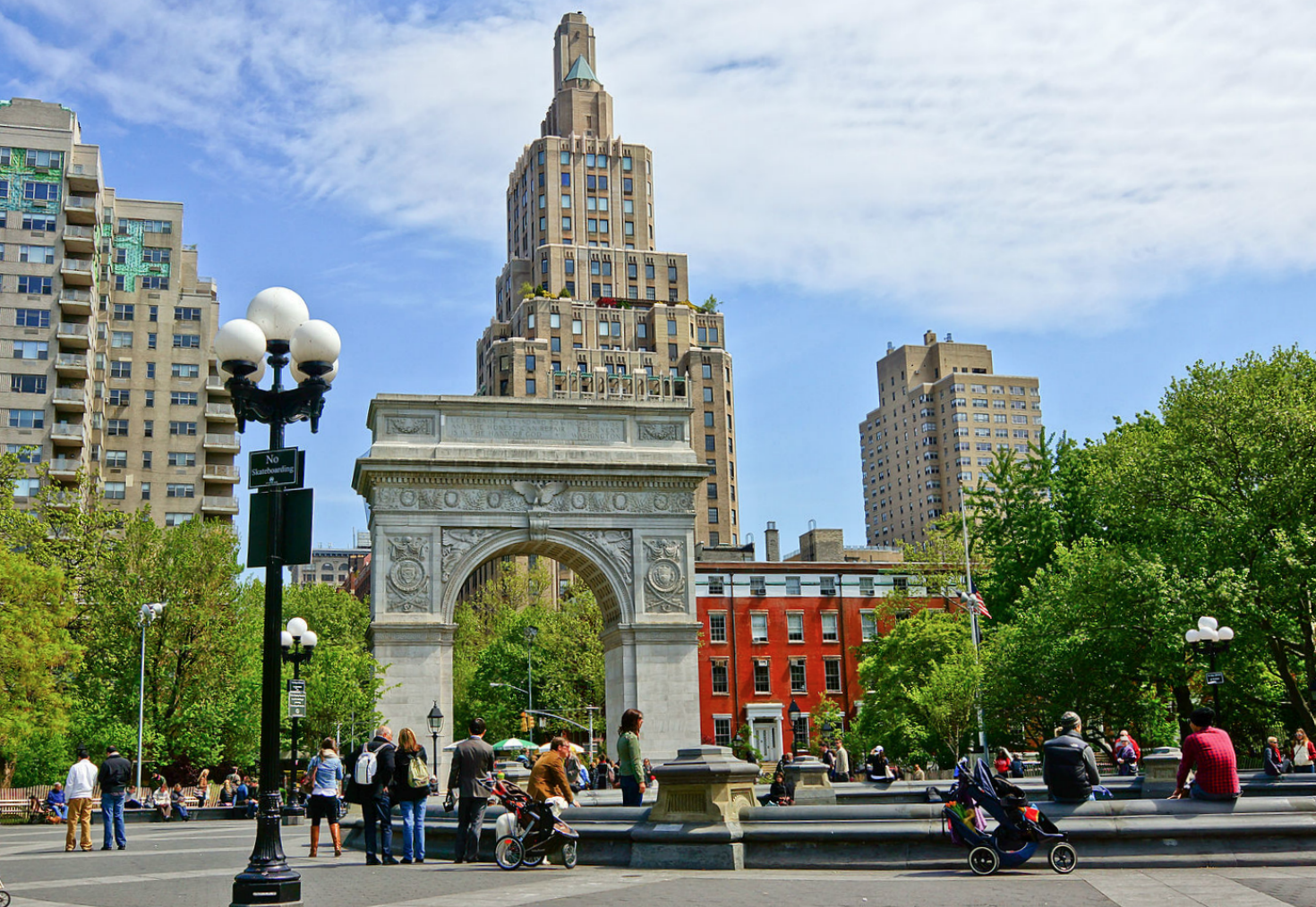 A view of the Washington Square Arch and fountain on a sunny day.