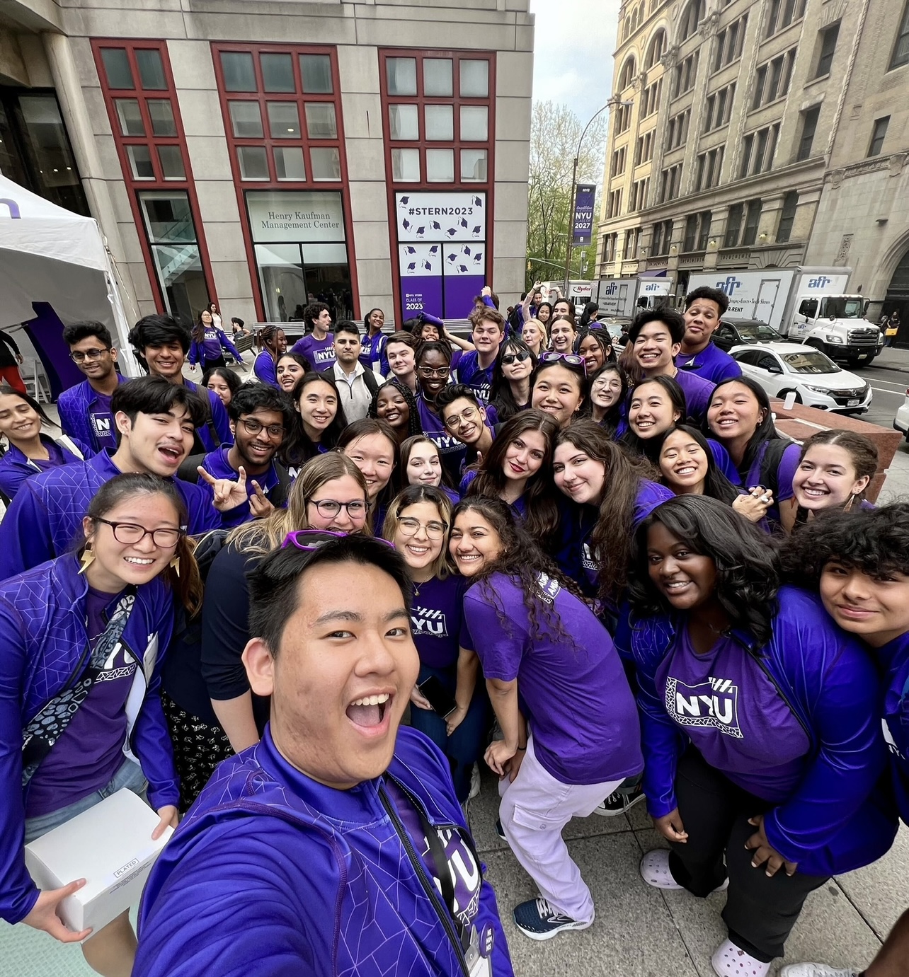 Dozens of purple jacketed student ambassadors pose for selfies
