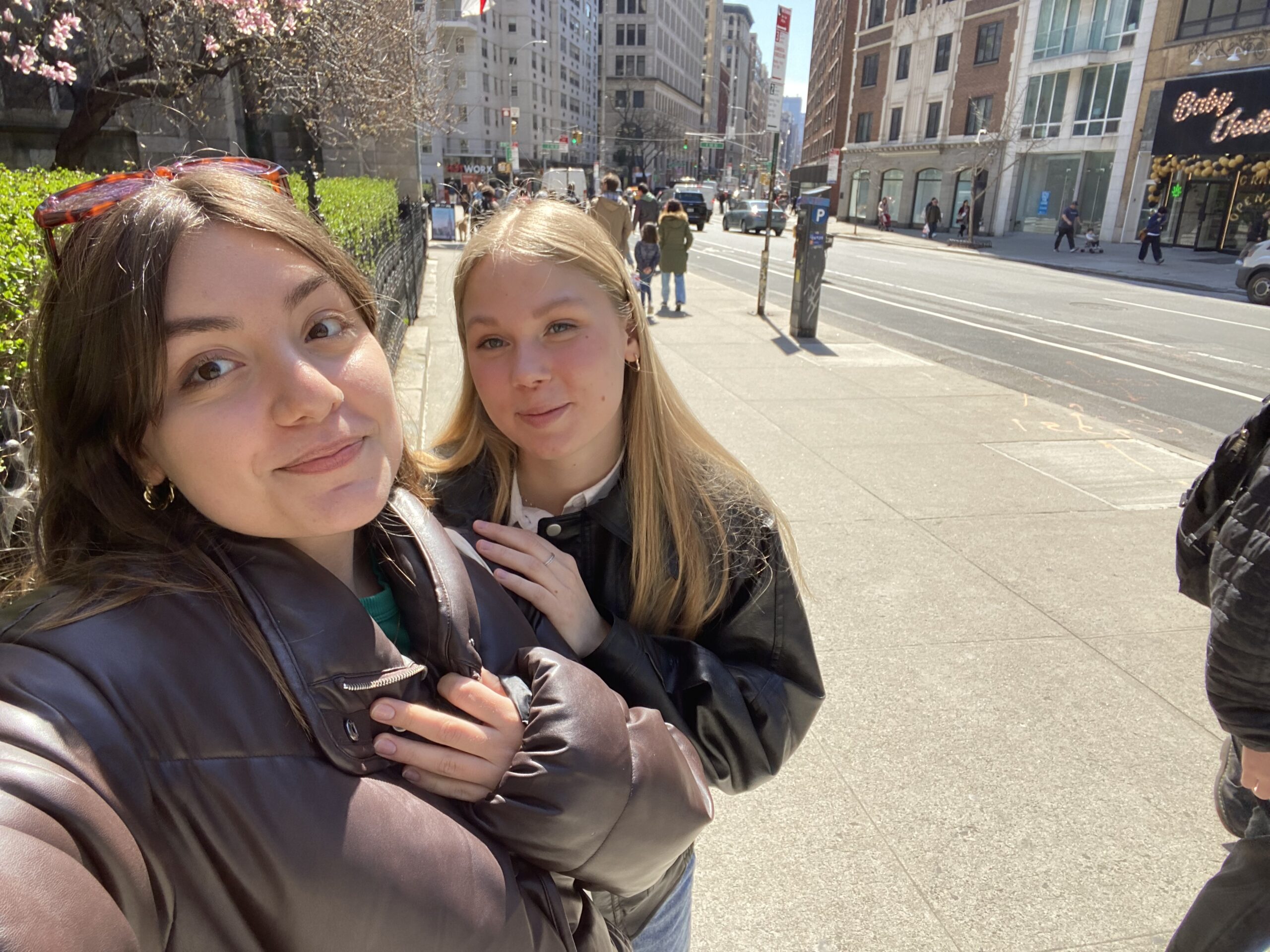 Amina poses for a selfie with a friend by a park in NYC