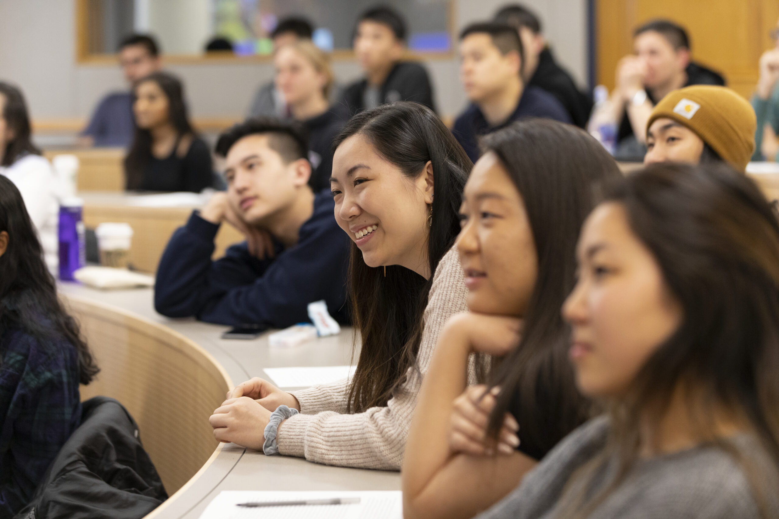 A group of students of color in a lecture hall.