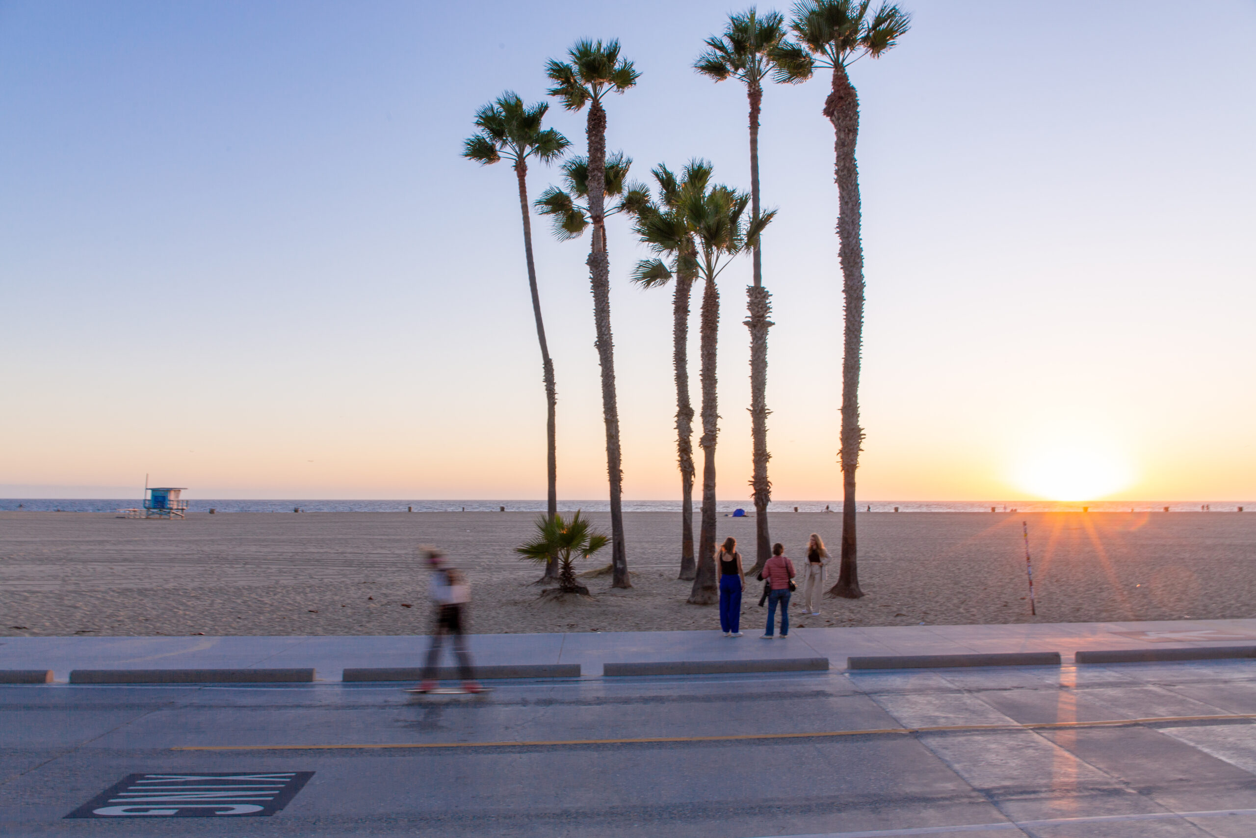 A boardwalk in Los Angeles at dusk.