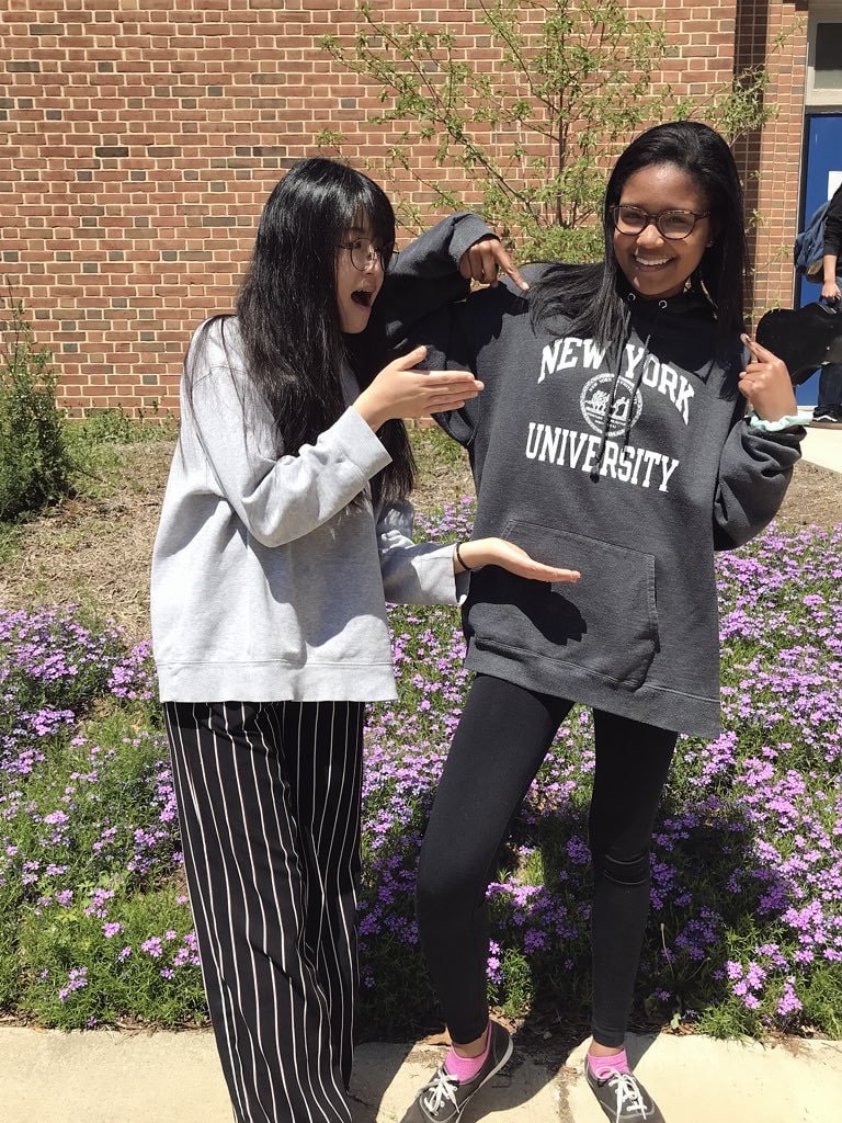 Zani and her friend pose with an NYU sweater