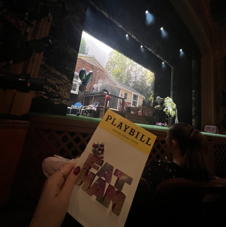 The “Fat Ham” Broadway playbill with the stage in the background.