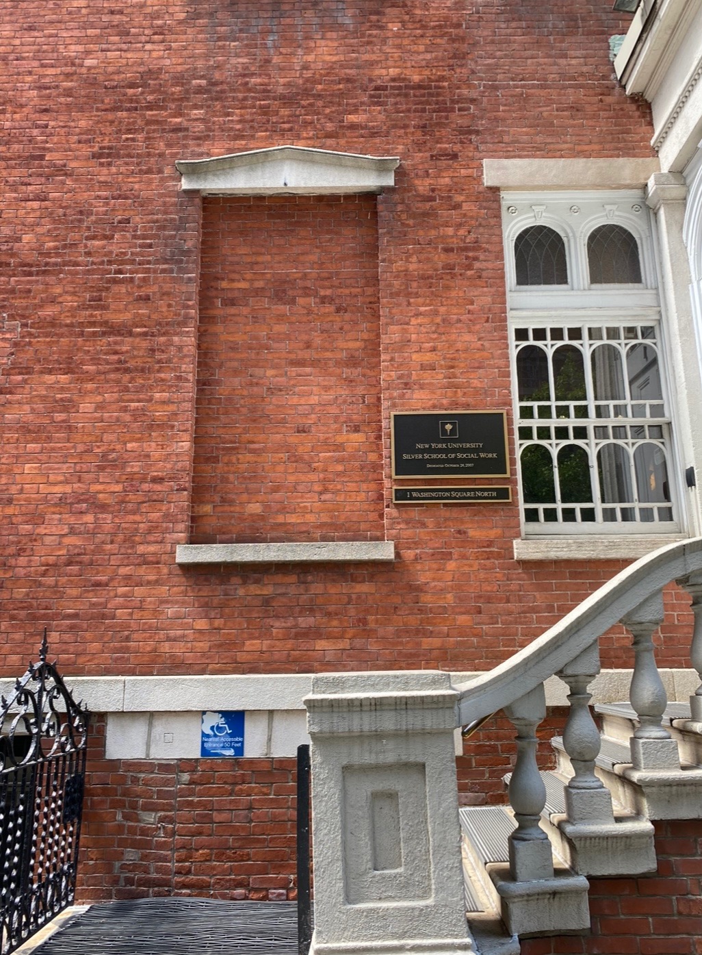 A brick building with stairs in front of it.