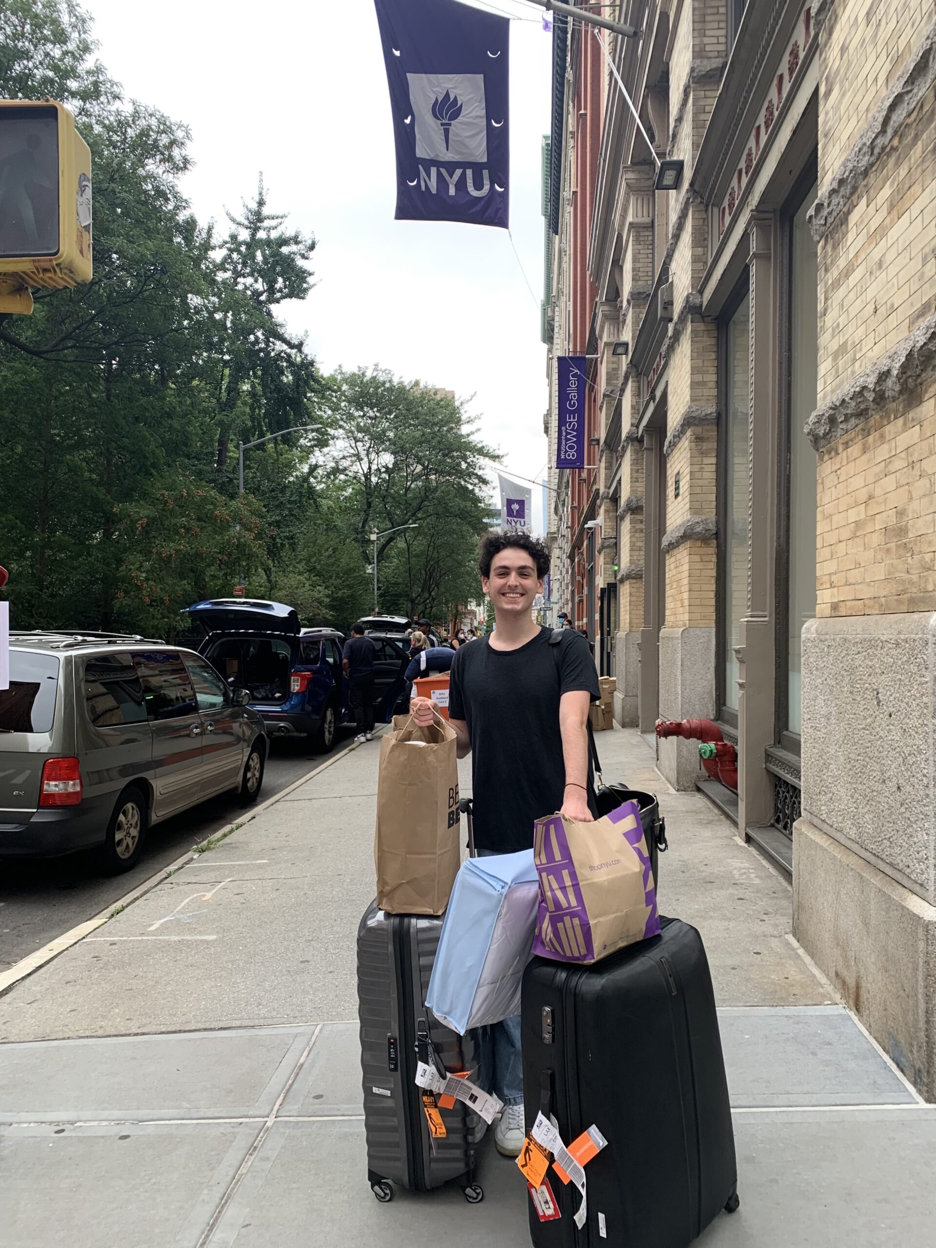 Myself standing outside one of the NYU First-Year dorms on Washington Square East, with an overwhelming number of suitcases and bags in my possession.
