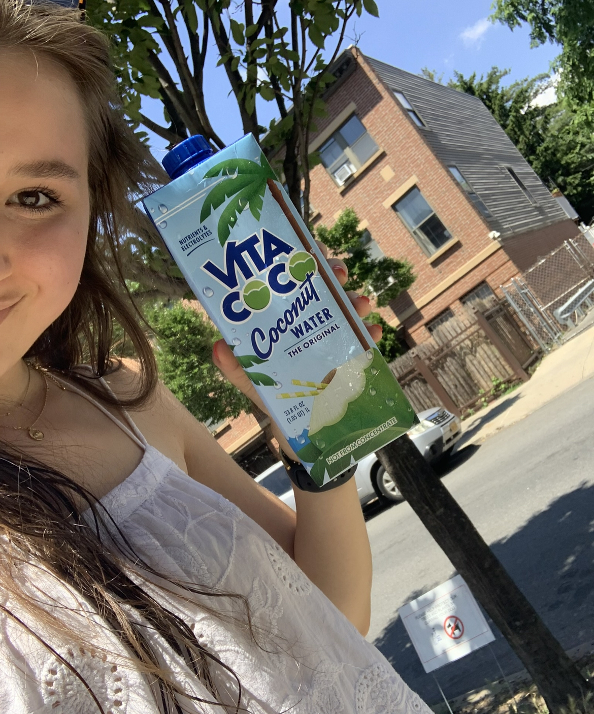 The author holding up a carton of Vita Coco coconut water.