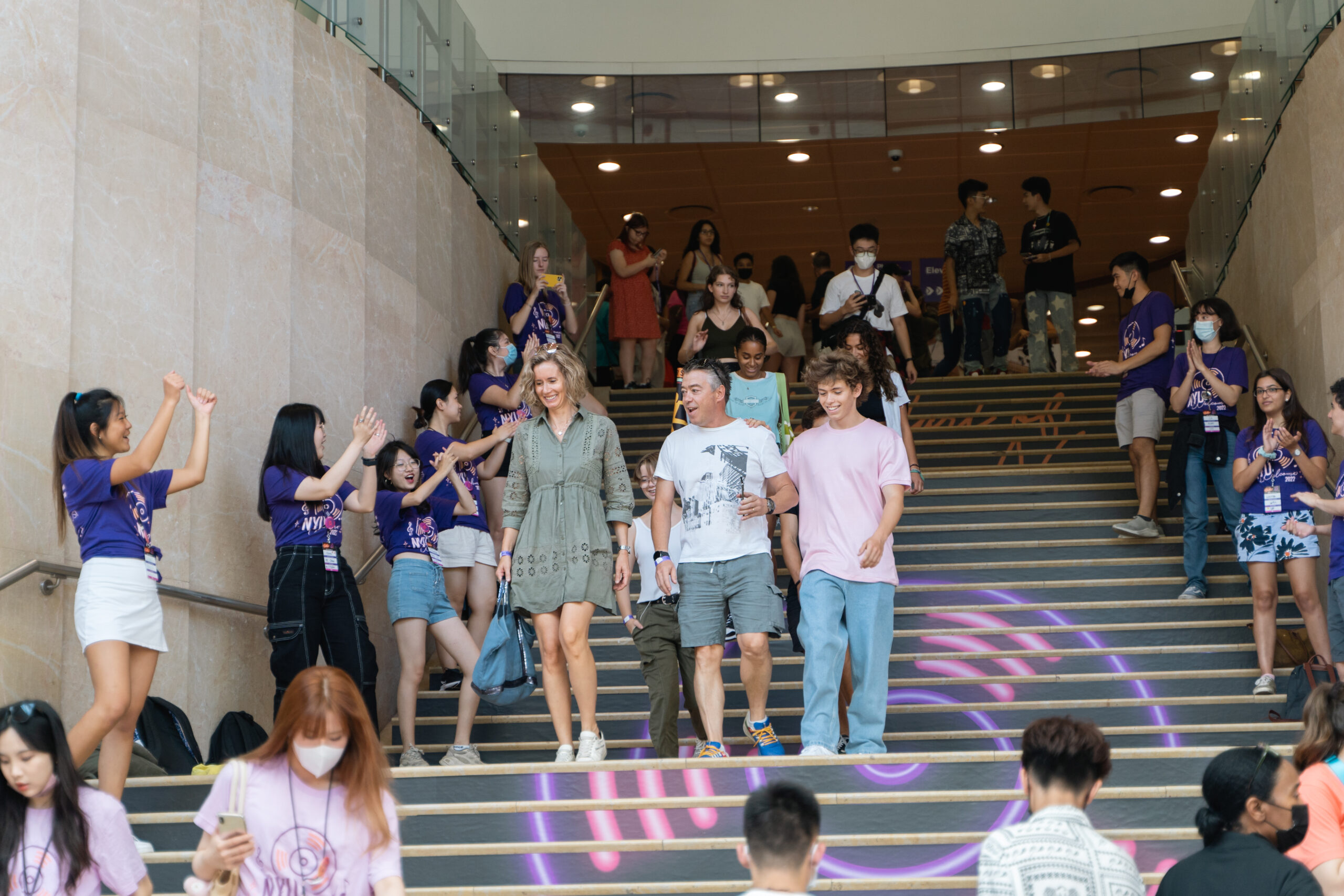 Parents descending the stairs at the NYU Kimmel Center for University Life during move-in weekend.