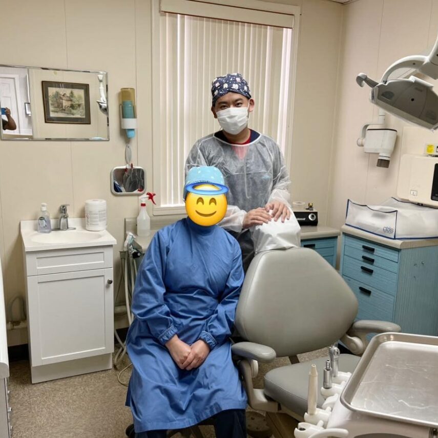 Two people wearing scrubs in a doctor’s office.