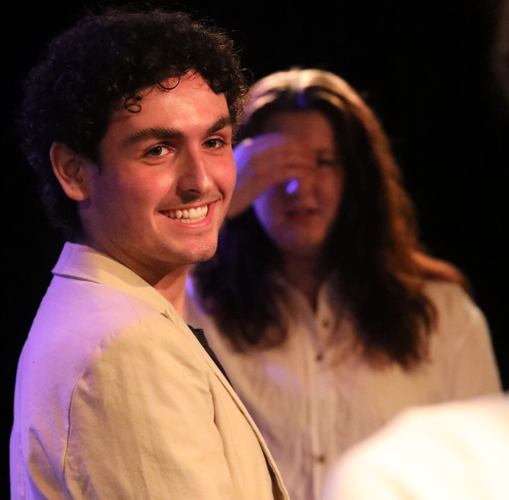 The author smiling with their cast during the curtain call of “A Midsummer Night’s Dream.”
