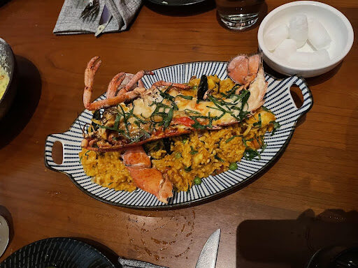 A dish of paella, with lobster.
